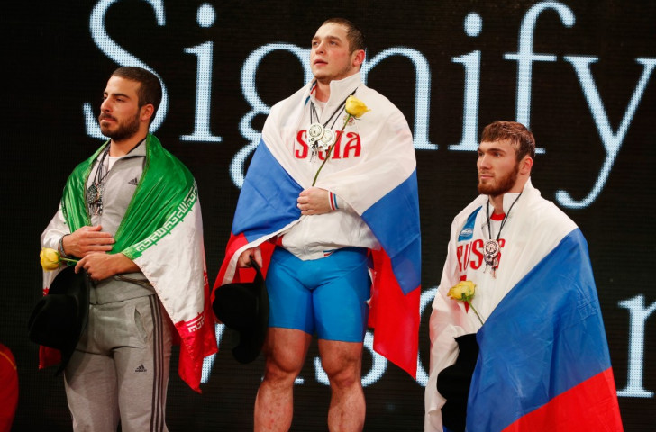 Okulov stands atop the men's 85kg overall podium ©Getty Images 