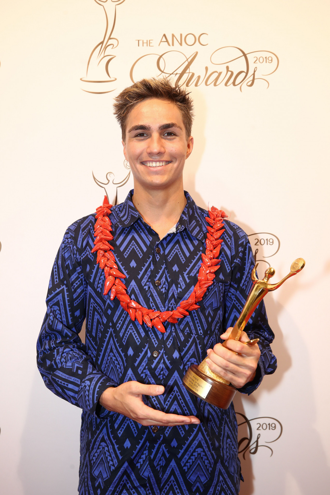 Samoa's home Pacific Games swimming hero Brandon Schuster clutches his best men's athlete prize ©ANOC