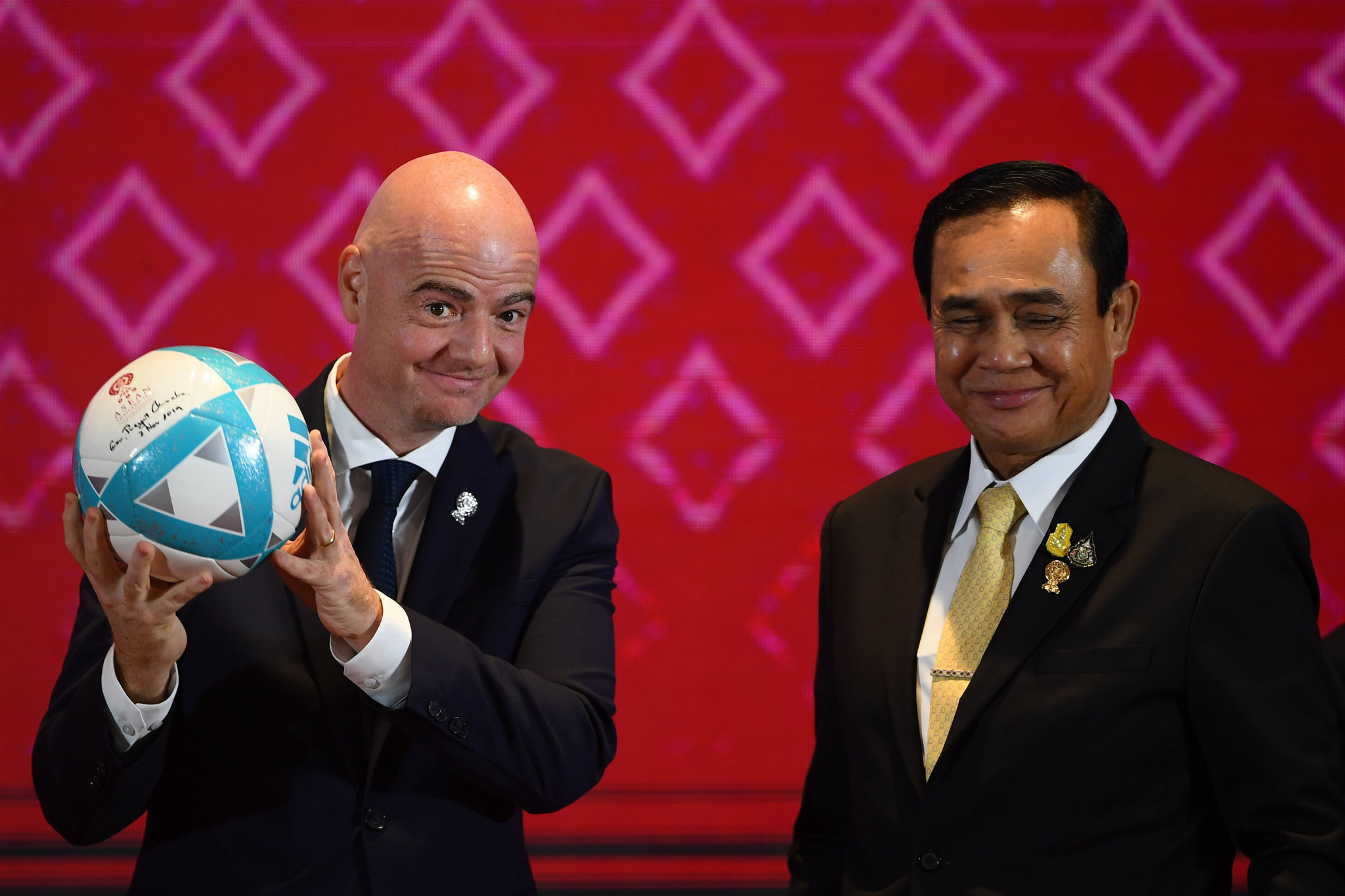 Gianni Infantino holds a football alongside Thailand's Prime Minister Prayut Chan-O-Cha ©Getty Images