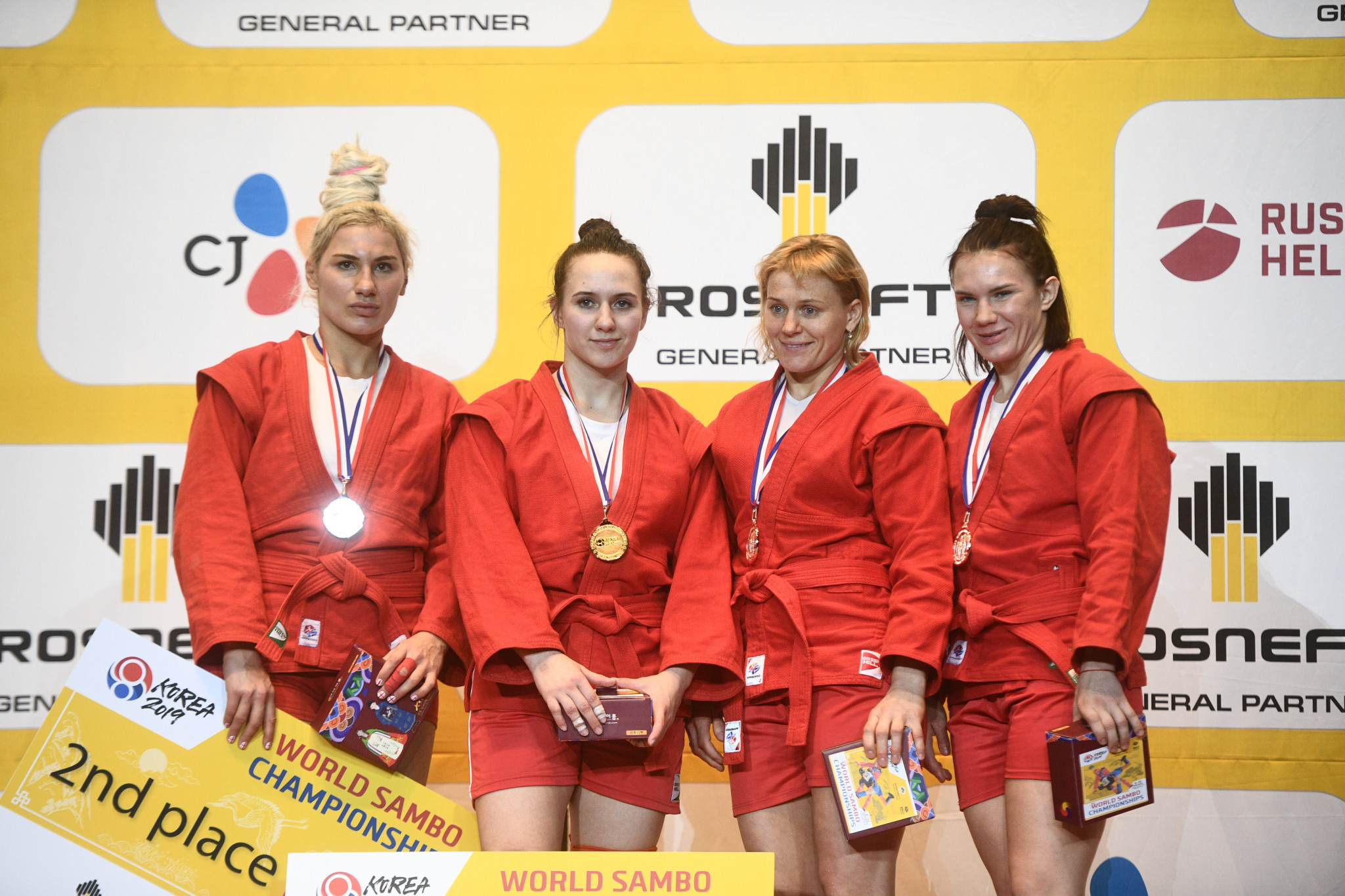 Anastasiia Khomiachkova of Russia, second left, topped the podium in the women's 72kg World Sambo Championship ©FIAS 