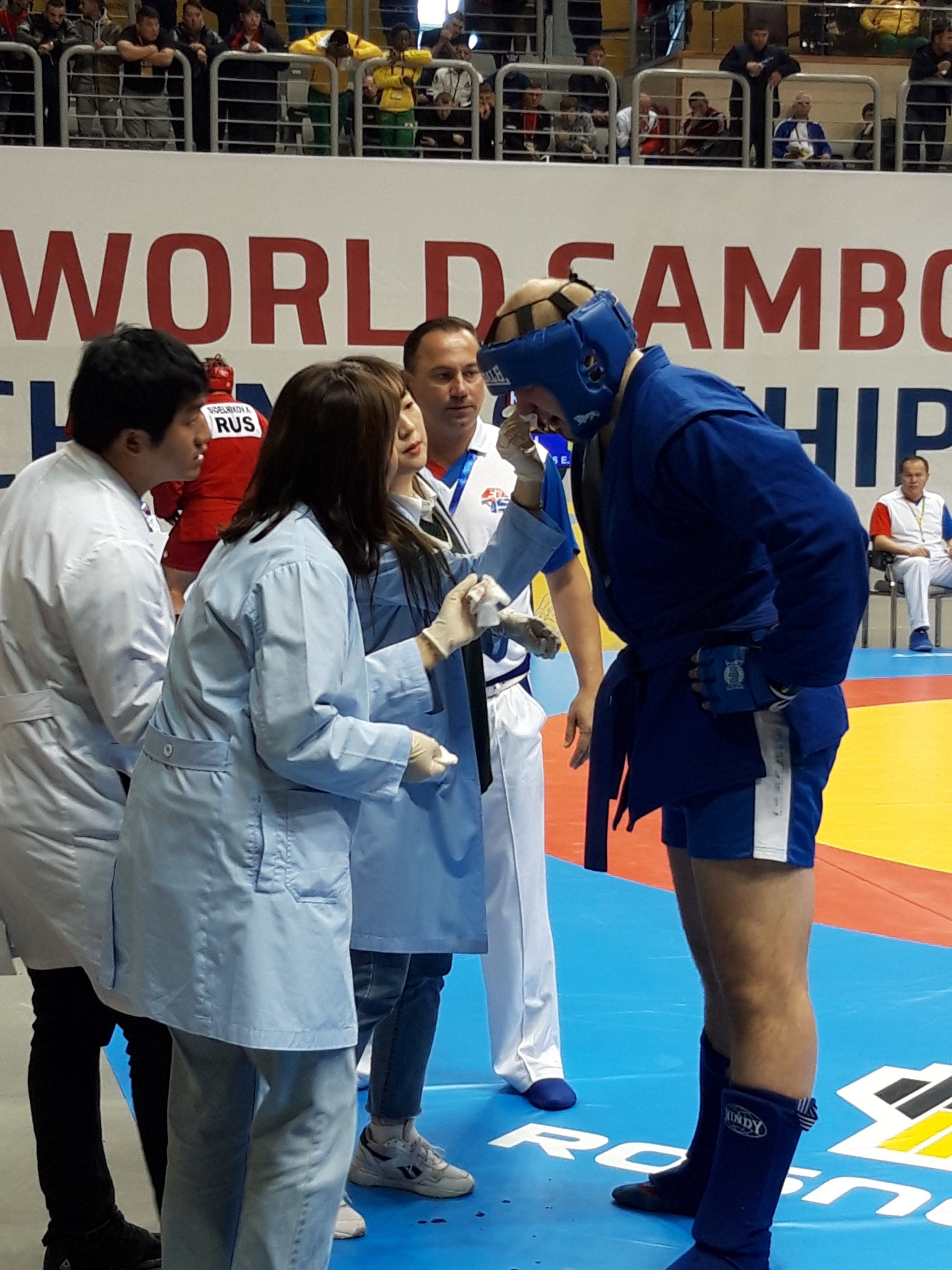 Eimantas Vaikasas of Lithuania receives medical support in the combat sambo over 100kg preliminary rounds ©ITG 