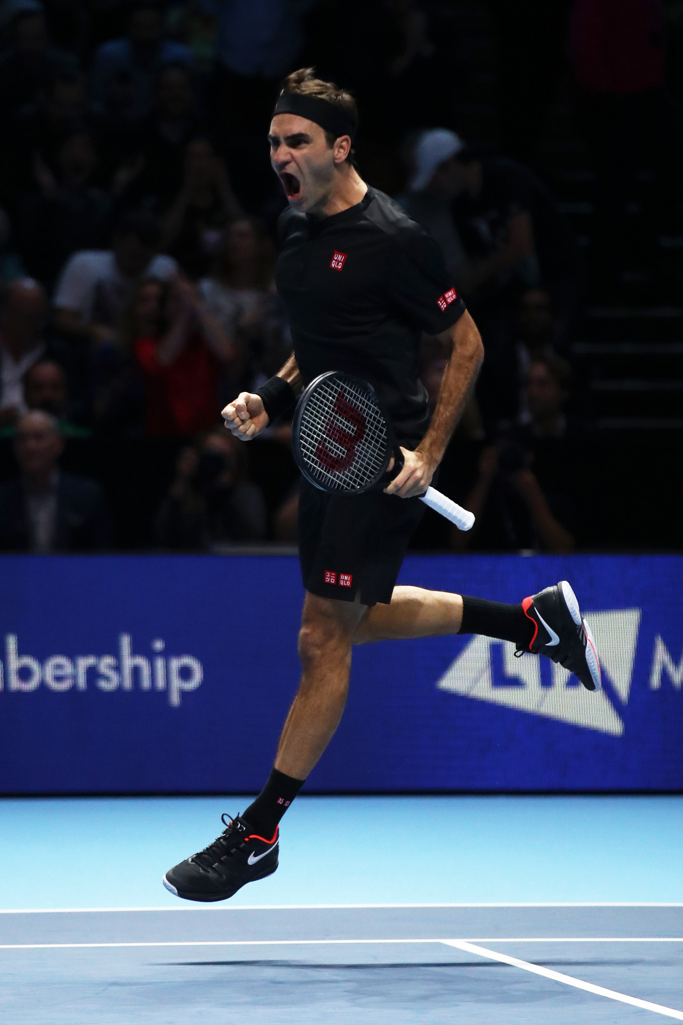 Roger Federer leaps for joy after beating Novak Djokovic to reach the last four of the ATP Finals ©Getty Images