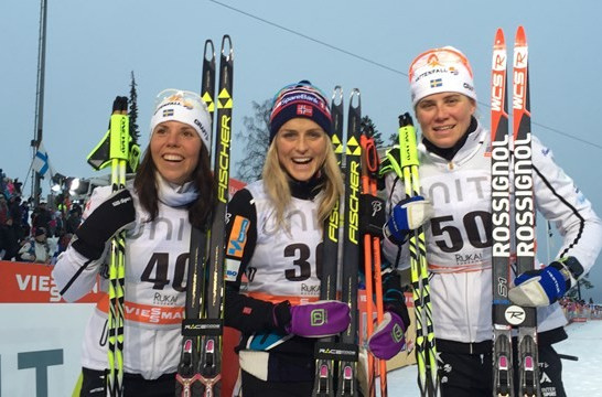 Therese Johaug (centre) celebrates after her 5km victory in the Finnish resort ©FIS