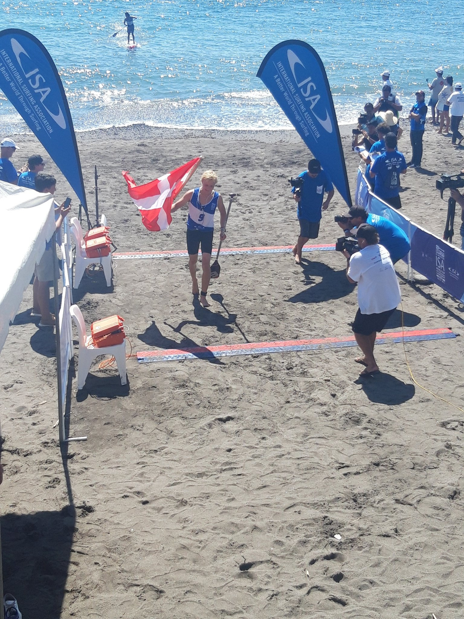 Christian Andersen of Denmark crosses the line to win the men's junior SUP technical final ©ITG 