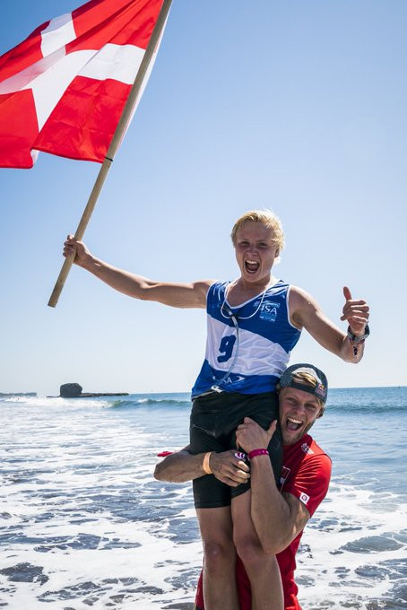 International Surfing Association vice-president Casper Steinfath celebrates with teenager Christian Andersen of Denmark after his junior SUP technical race gold ©ISA 
