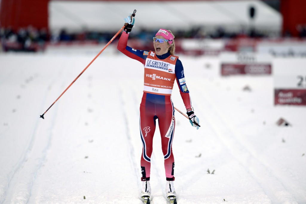 Therese Johaug celebrates after crossing the finish line to claim the women's title in Ruka ©AFP/Getty Images