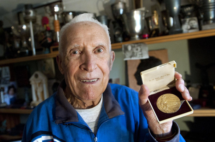 A 90-year-old Alain Mimoun with the Olympic marathon gold medal he won at Melbourne 1956 ©Getty Images