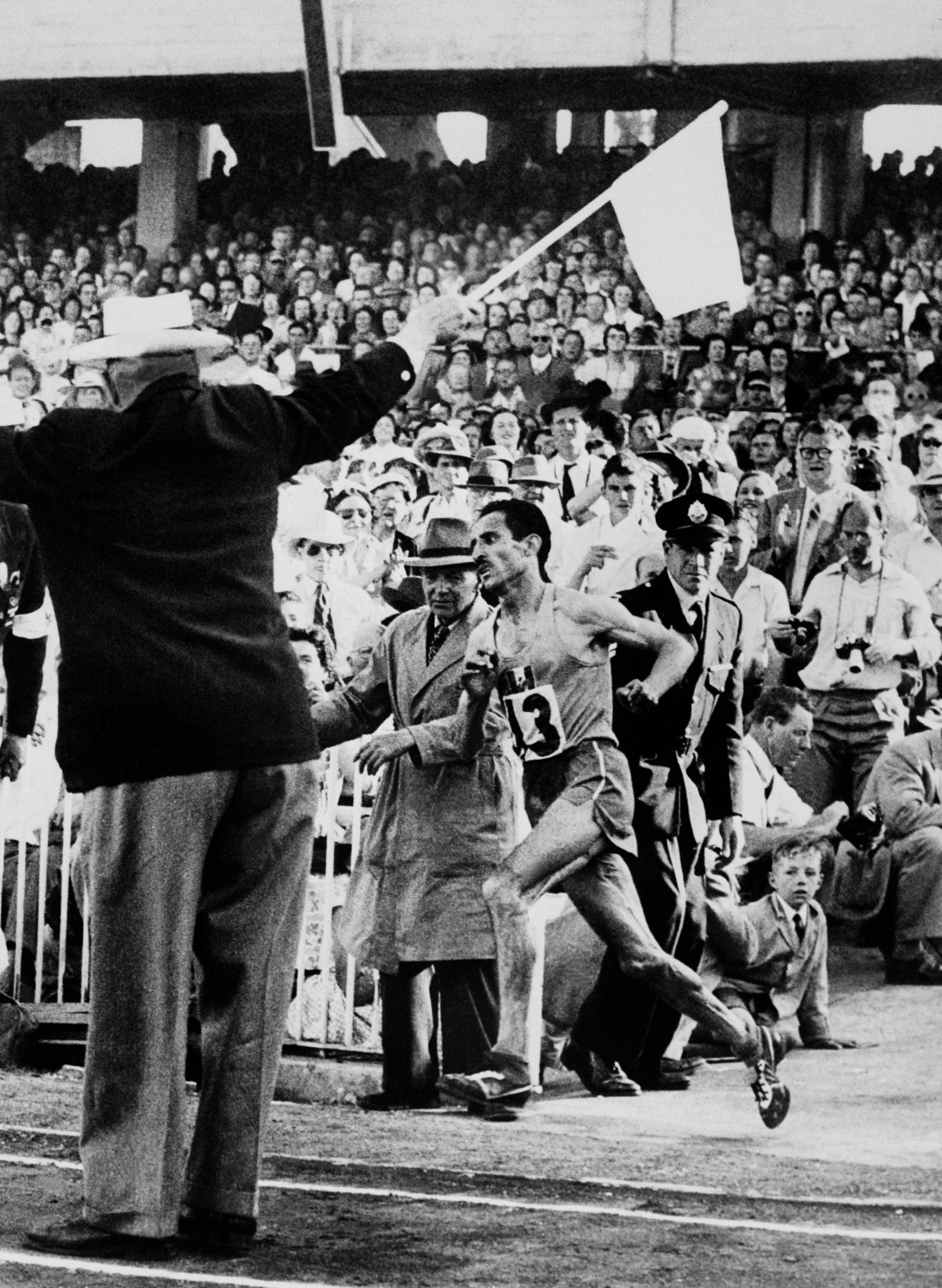 With Olympic glory awaiting, Alain Mimoun enters the Melbourne Cricket Ground in 1956 as 110,000 spectators make a noise he later compared to an 
