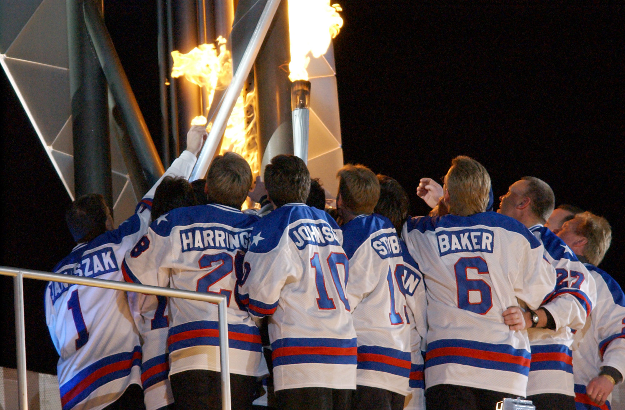 The 1980 US hockey team hold the Olympic Torch during the Opening Ceremony of the 2002 Winter Olympics in Salt Lake City ©John MacDougall/AFP via Getty Images