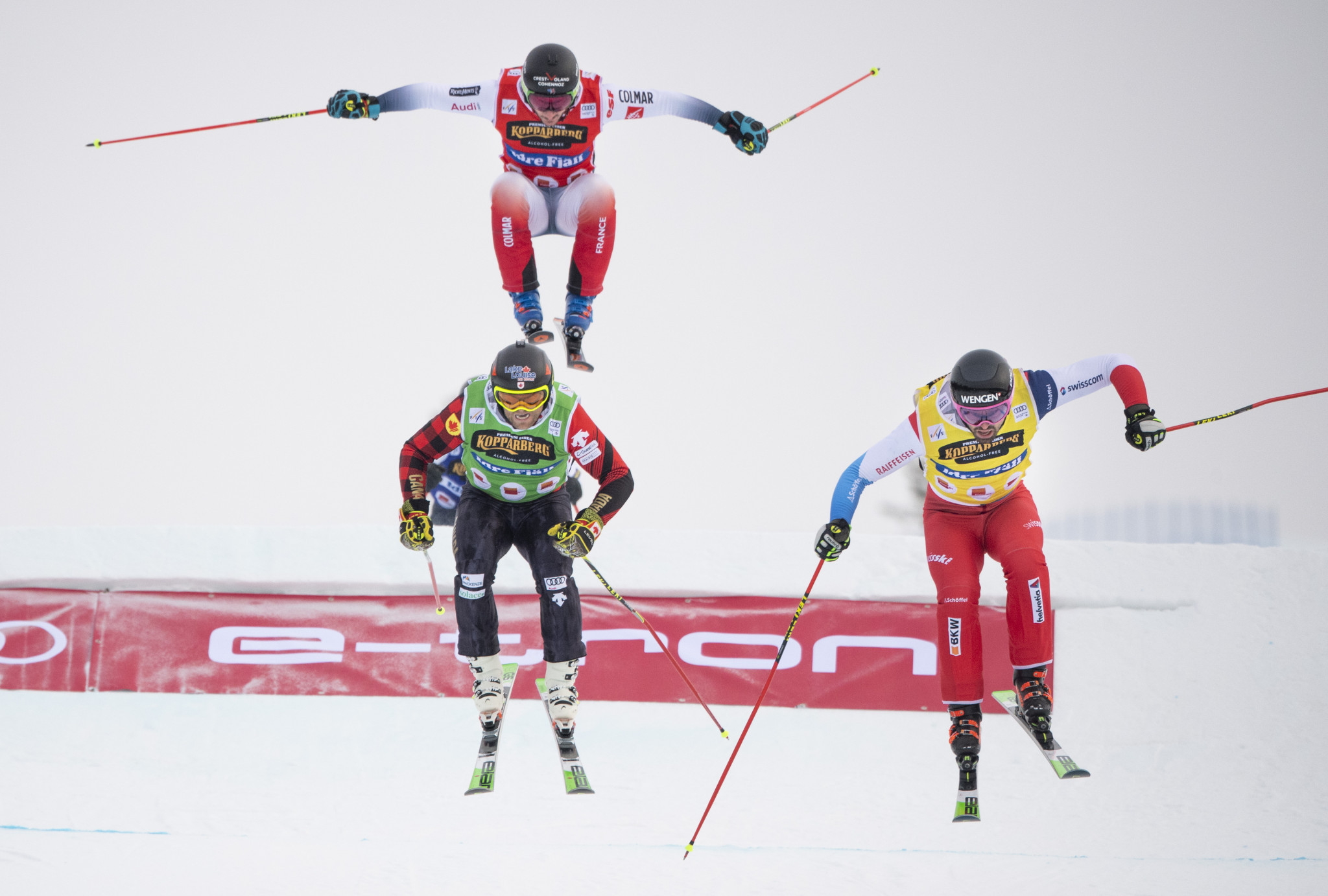 Ryan Regez of Switzerland, yellow, overtakes Brady Leman of Canada, green, in the final jump ©Getty Images