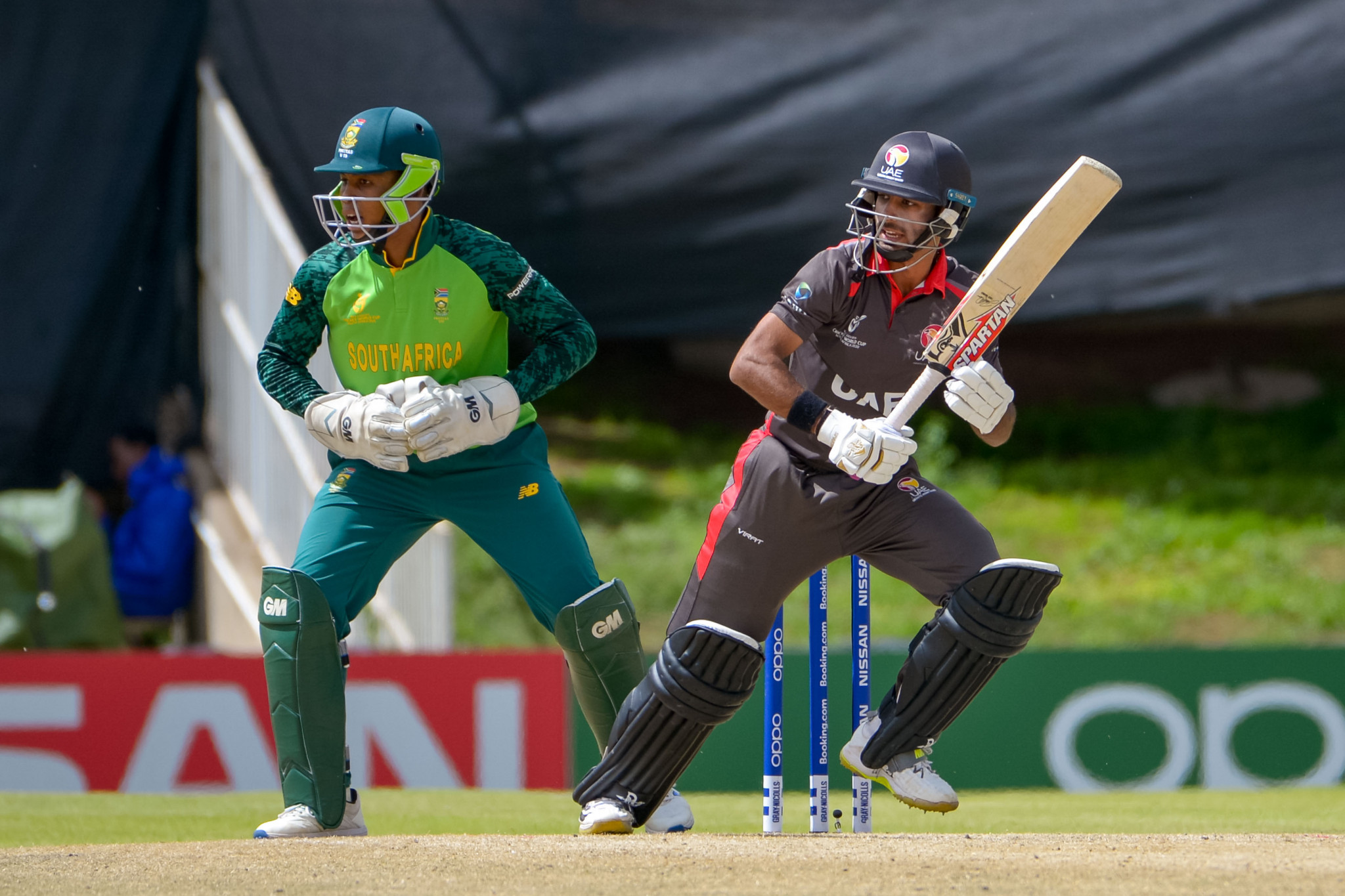 Ansh Tandon of UAE and Khanya Cotani of hosts South Africa in a match in Bloemfontein affected by the rain ©Getty Images