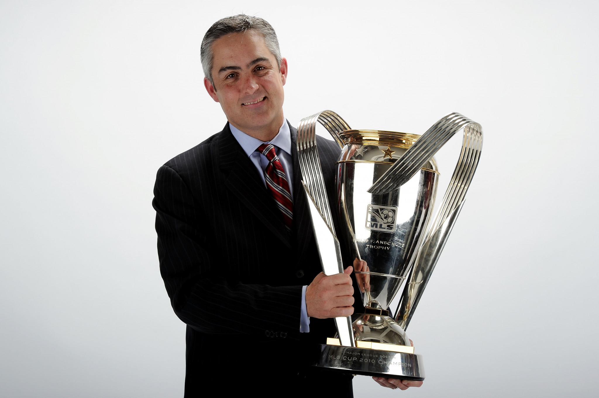 Jeff Plush poses with Colorado Rapids' MLS Cup in 2010 - he will now look to continue his success with USA Curling ©Getty Images
