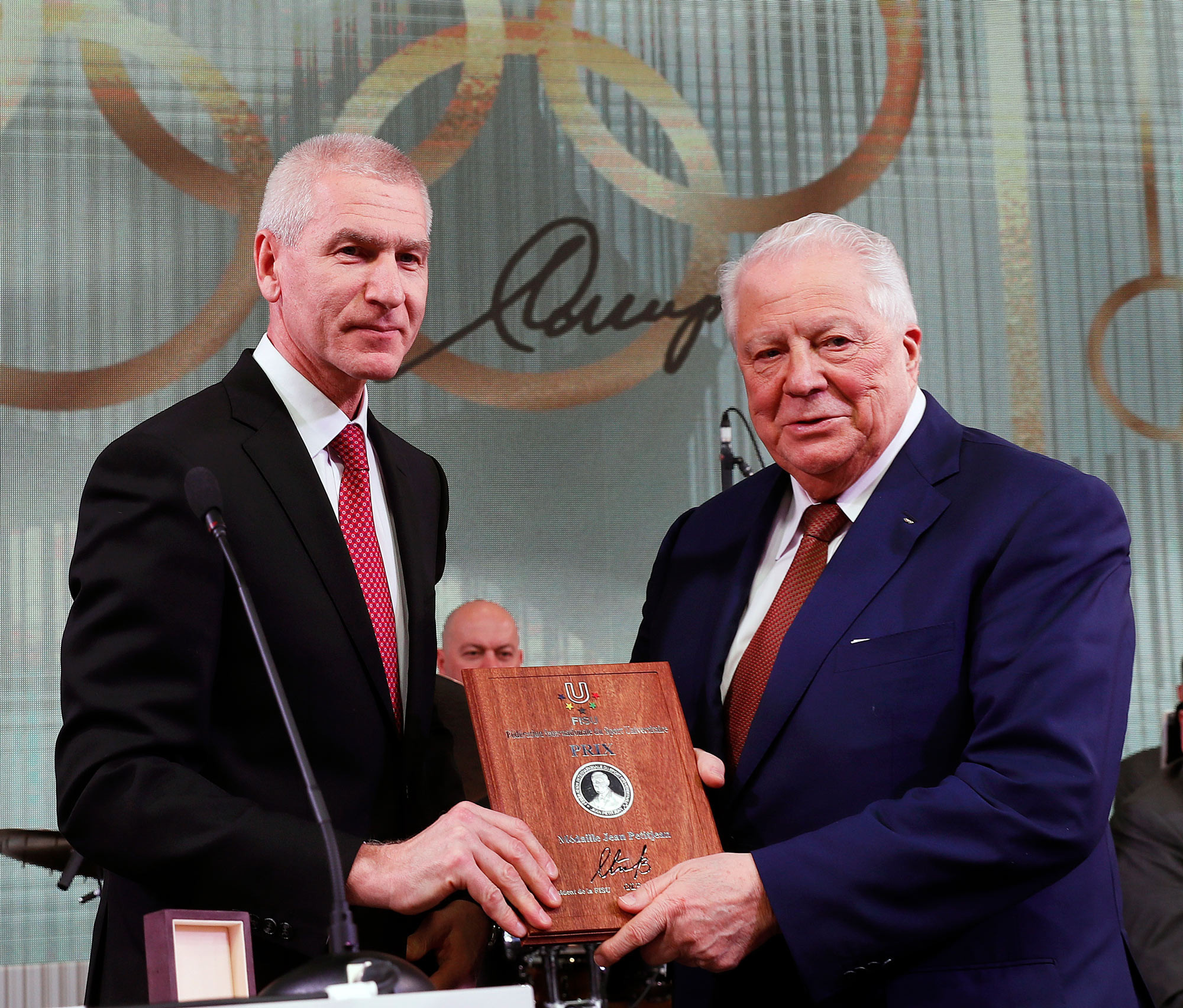 FISU President Oleg Matytsin, left, presented the Jean Peititjean Medal to Vitaly Smirnov ©FISU