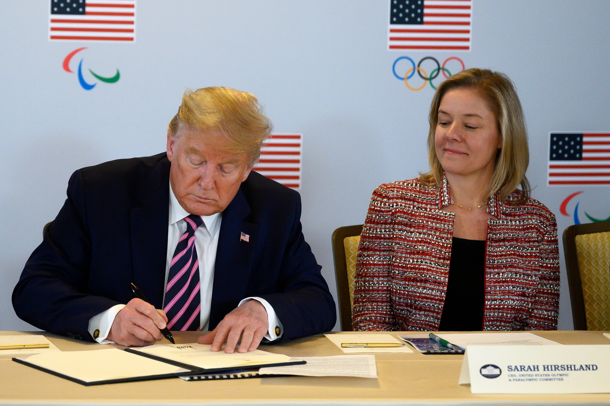 Donald Trump signs an agreement next to United States Olympic and Paralympic Committee chief executive Sarah Hirshland ©Getty Images