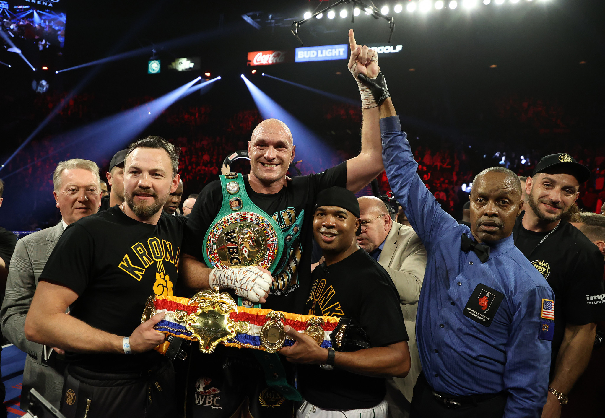 Tyson Fury holds his new belts along with his two Kronk Gym trainers, 'SugarHill' Steward and Andy Lee ©Getty Images