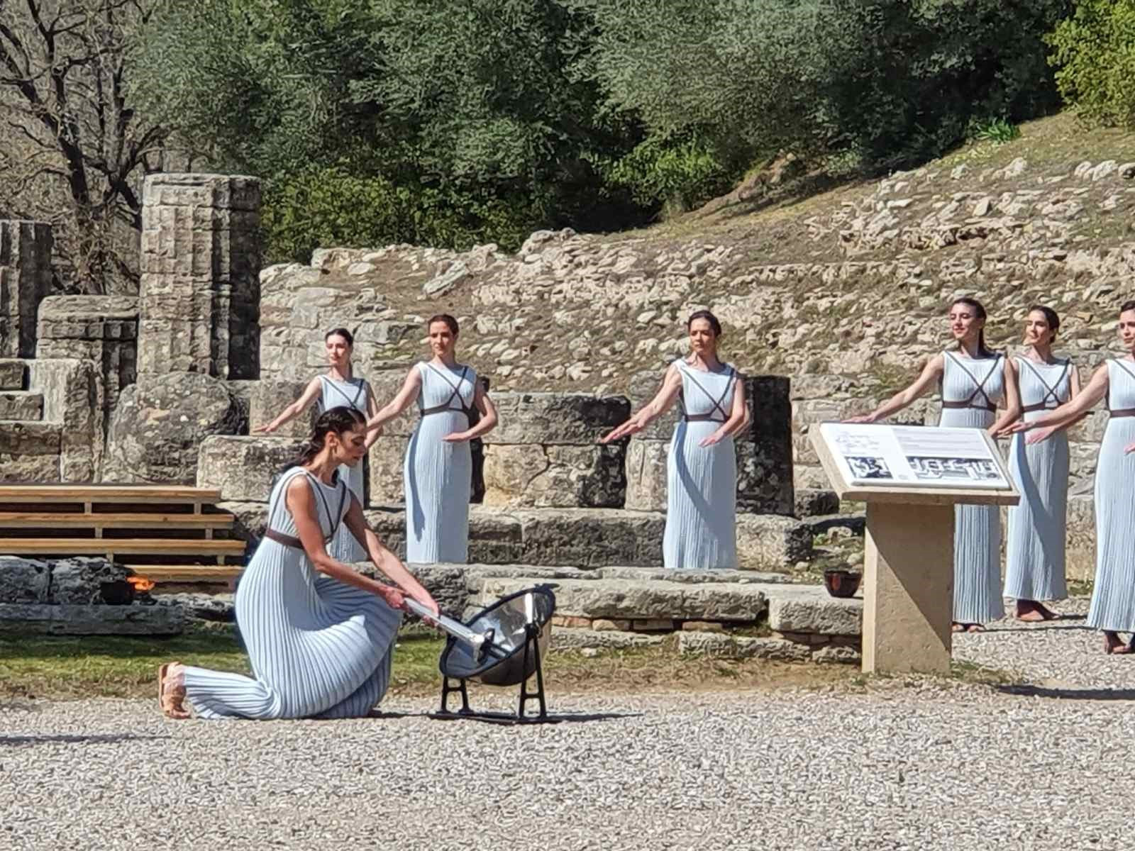 High Priestess Xanthi Georgiou lights the Olympic Flame during a dress rehearsal in Olympia today ©Hellenic Olympic Committee