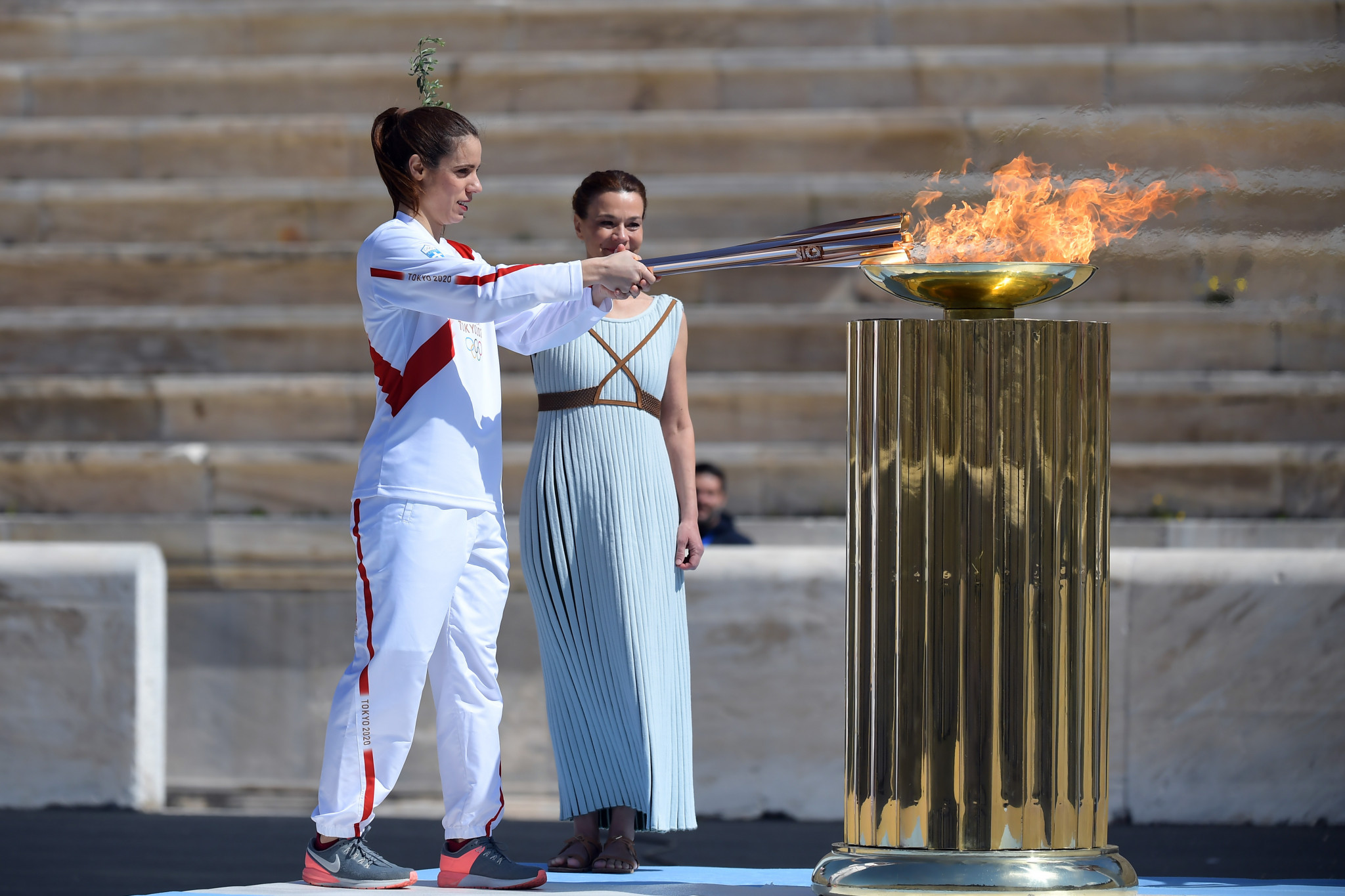Greek pole vaulter Katerina Stefanidi lights a cauldron in the stadium ©Getty Images