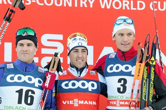 Federico Pellegrino (centre) celebrates his FIS Cross Country World Cup victory in Toblach today ©FIS/Nordic Focus