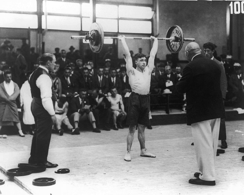 Alf Baxter of Great Britain competes in a weightlifting event at the Amsterdam Olympics, 30th July 1928. © Central Press/Hulton Archive/Getty Images.