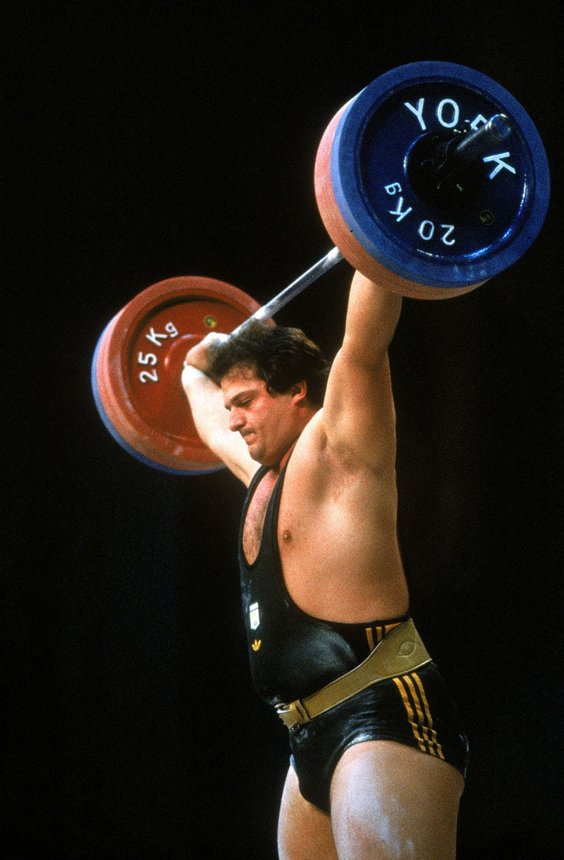 Dean Lukin of Australia on his way to winning gold in the Mens Weightlifting during the Olympic Games in Los Angeles, USA. © Getty Images.