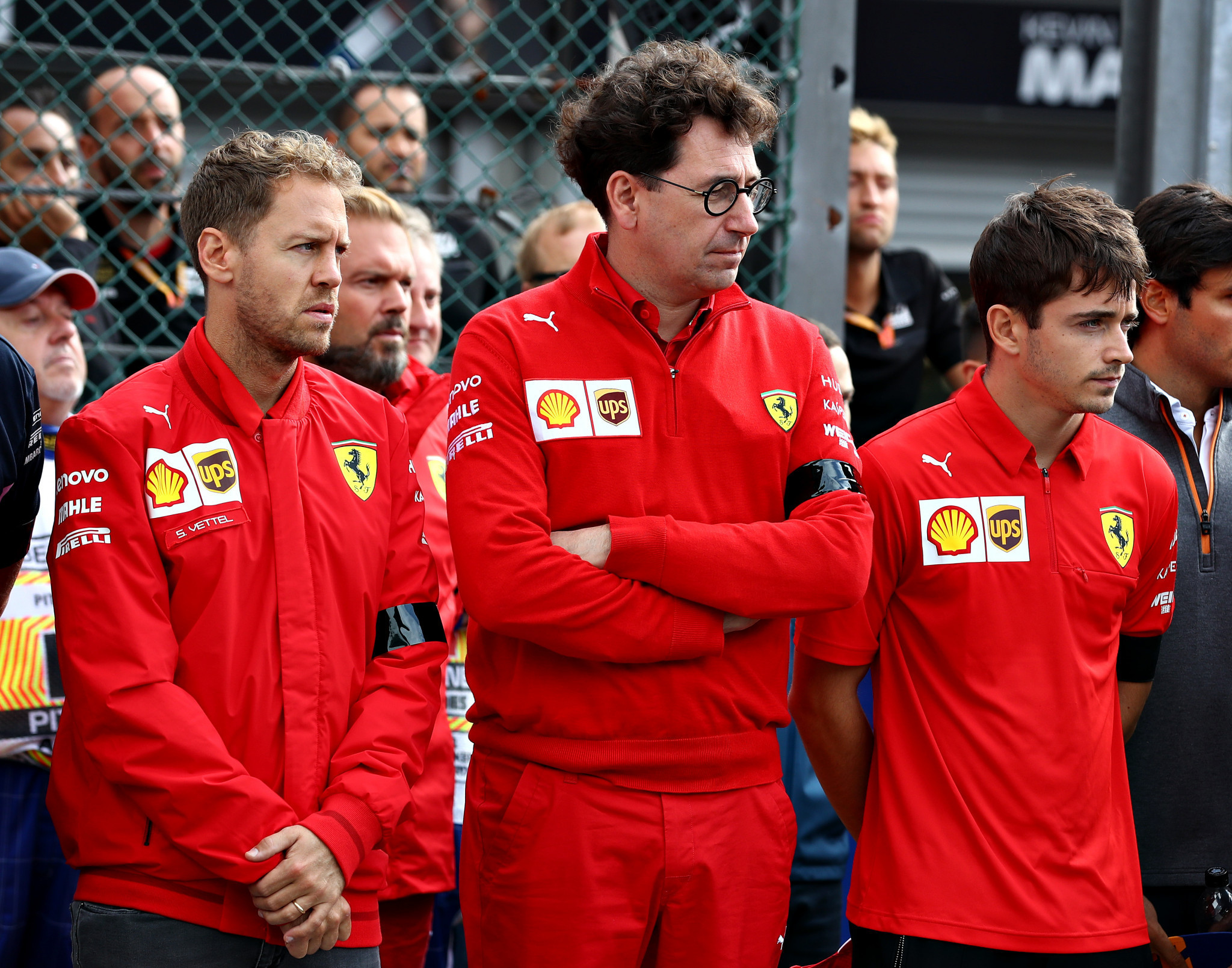 Charles Leclerc, right, pictured with teammate Sebastian Vettel, left, and team principal, Mattia Binotto, centre, has been accused of breaching social distancing rules ©Getty Images