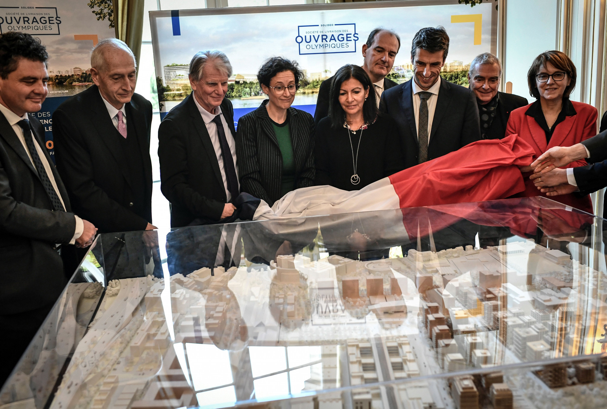 Michel Cadot, second left, looks at a model of the Paris 2024 Olympic Village in a group including Paris Mayor Anne Hidalgo, centre, Jean Castex, fourth from right, and Paris 2024 President Tony Estanguet, third from right ©Getty Images