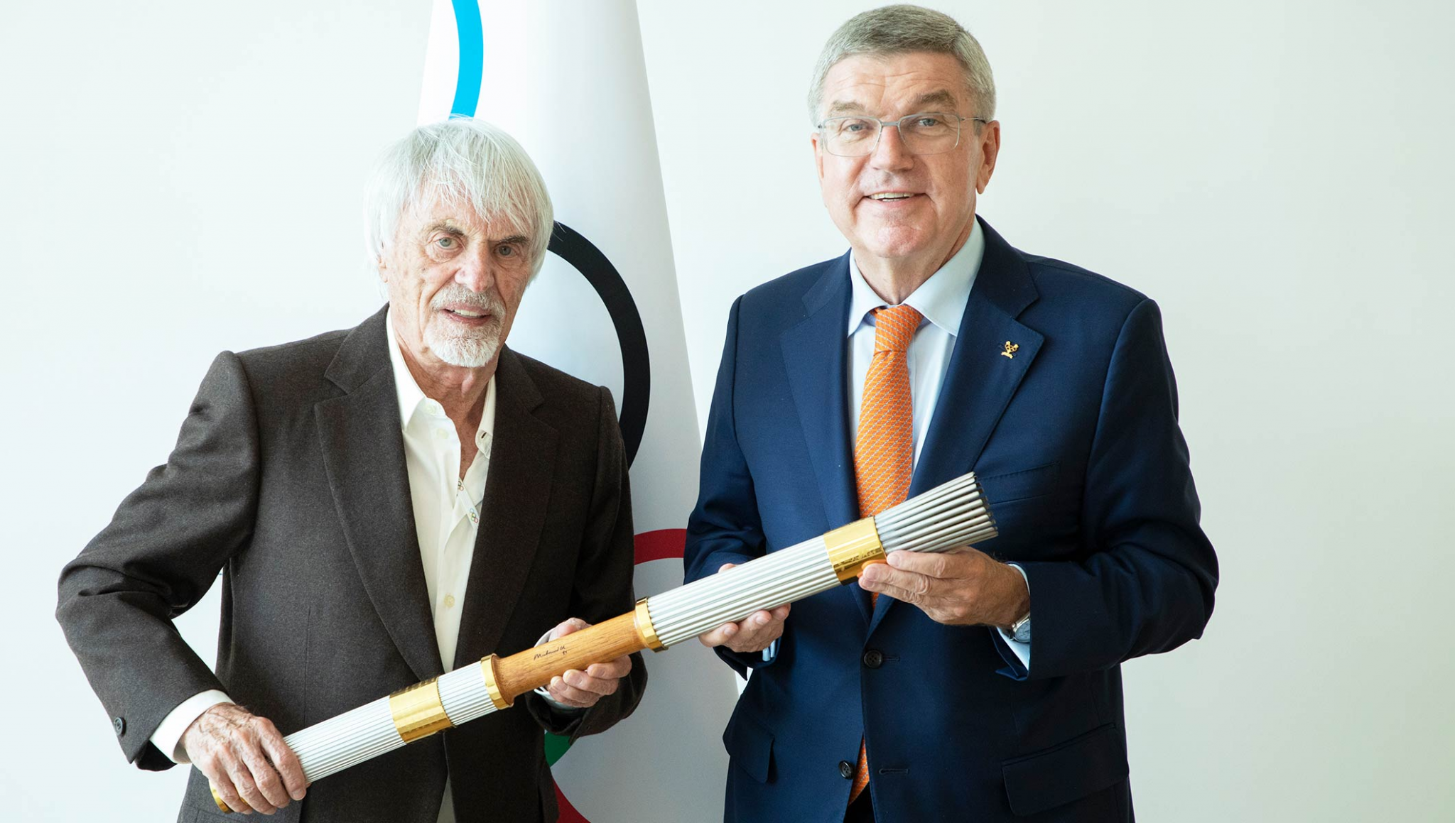 Bernie Ecclestone, left, donated the Olympic Torch used by Muhammad Ali at Atlanta 1996 to the IOC ©IOC