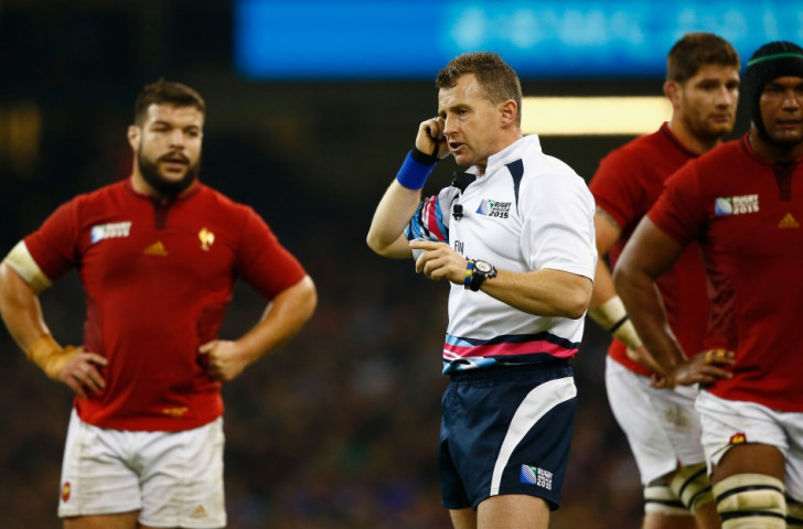 Referee Nigel Owens confers with the Television Match Official (TMO) in the stands during the 2015 Rugby World Cup quarter-final between France and New Zealand FIFA's Board in charge of the Rules of the Game, IFAB, will discuss the introduction of video replays this month ©Getty Images