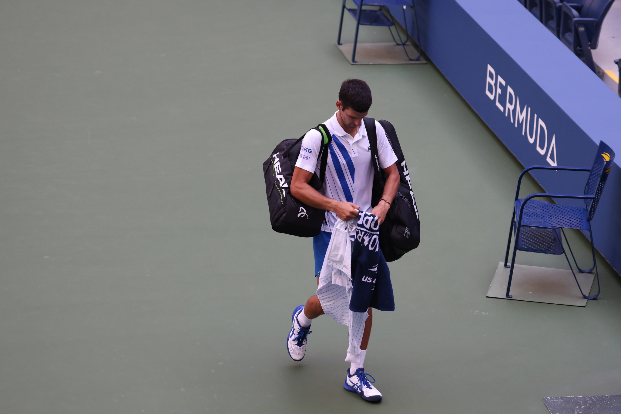 Novak Djokovic leaves the Arthur Ashe Stadium court after being disqualified from the US Open ©Getty Images
