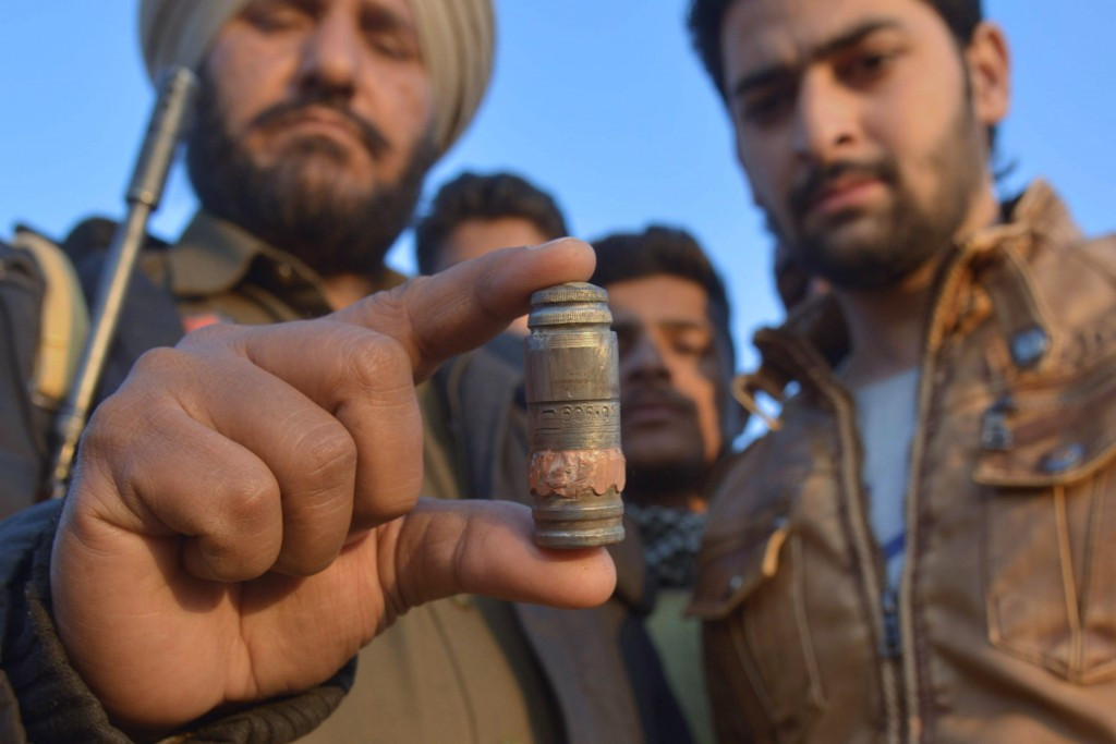 Indian police personnel display a cartridge shell near the air force base in Pathankot which claimed the live of Commonwealth Shooting Championships gold medallist Fateh Singh ©AFP/Getty Images