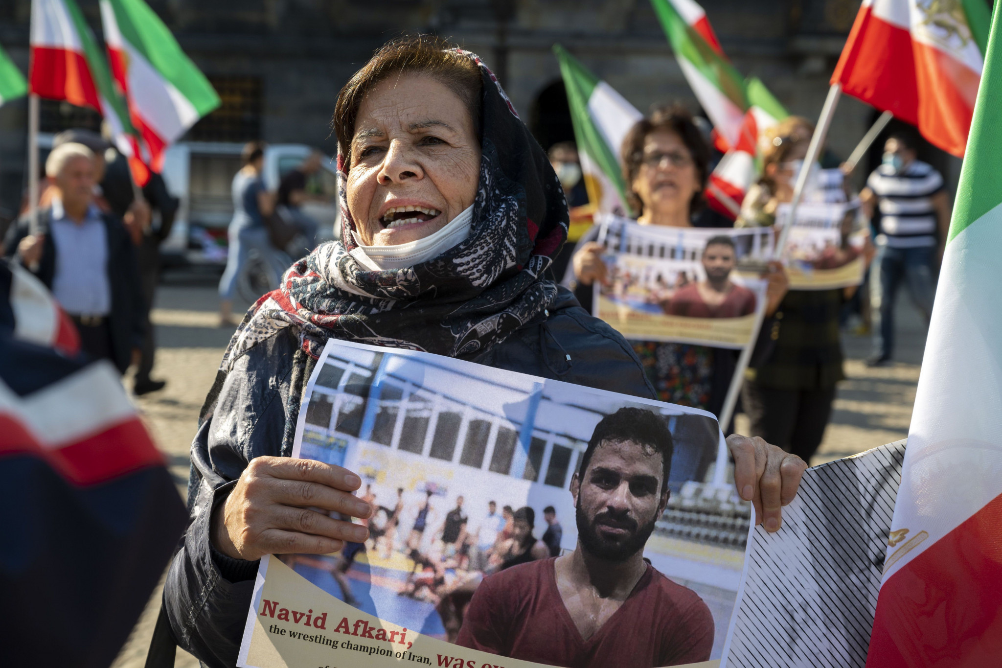 A demonstrator holds an image of Navid Afkari at a protest against the Iranian regime held in Dutch city Amsterdam ©Getty Images