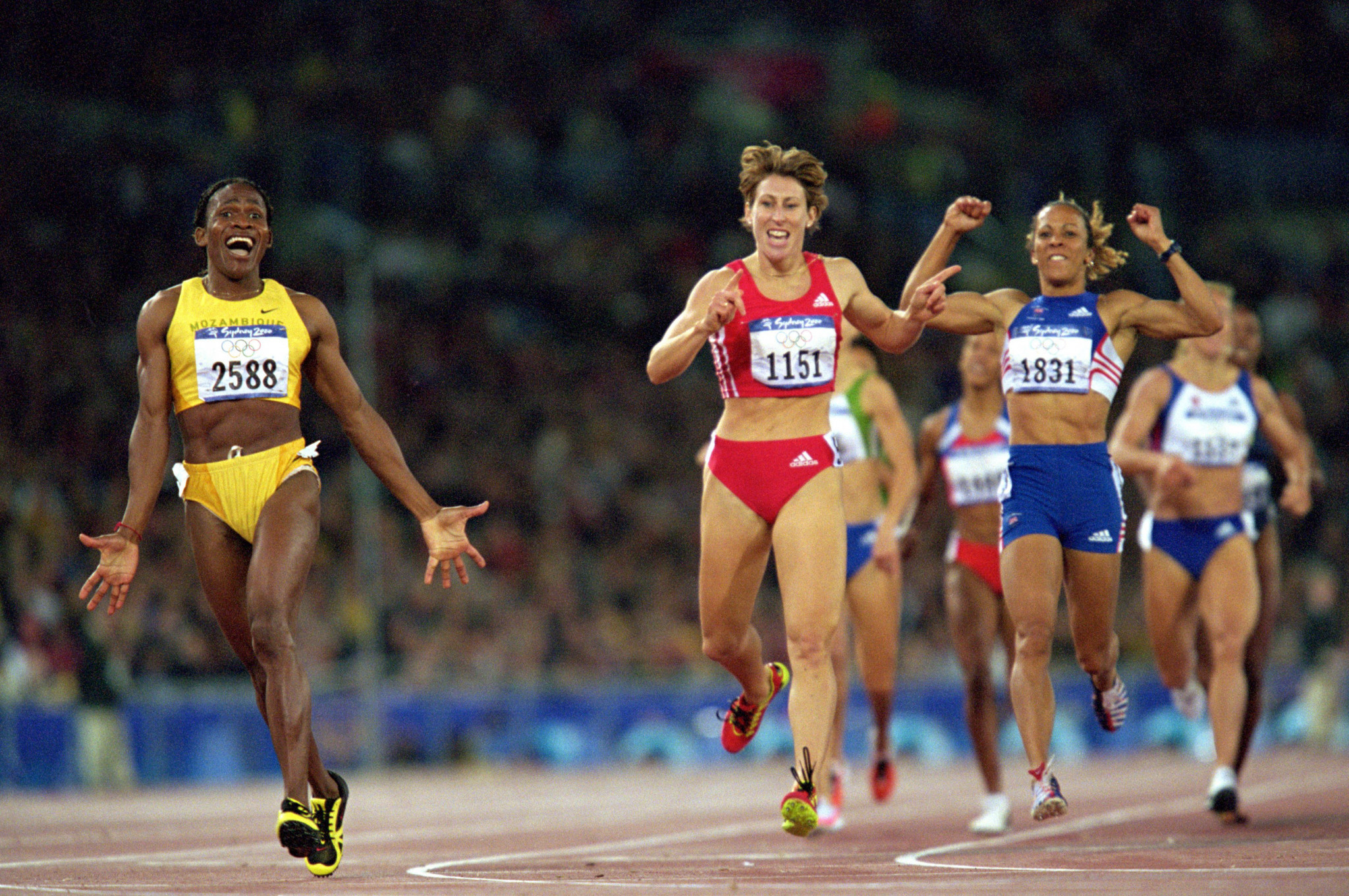 Mozambique's Maria Mutola shows her delight at winning the 800m at Sydney 2000 as the silver and bronze medallists, Austria's Stephanie Graf and Britain's Kelly Holmes, seem just as pleased ©Getty Images