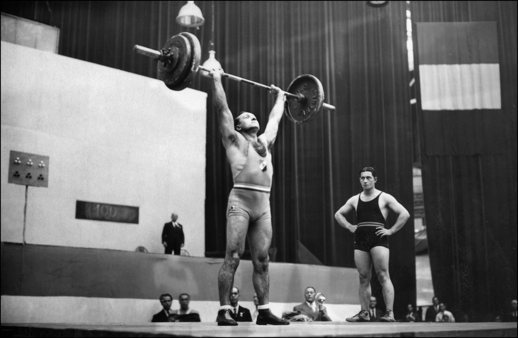 Louis Hostin, best French medal winner in his category, lift weight, 15 September 1937. After taking silver in the Light Heavyweight at the 1928 Olympics in Amsterdam, Hostin won two gold medals at the 1932 los Angeles Olympics and 1936 Berlin Olympics. He was also European champion in 1930 and 1935 and world vice-champion in 1937. Photo credit AFP/AFP via Getty Images.