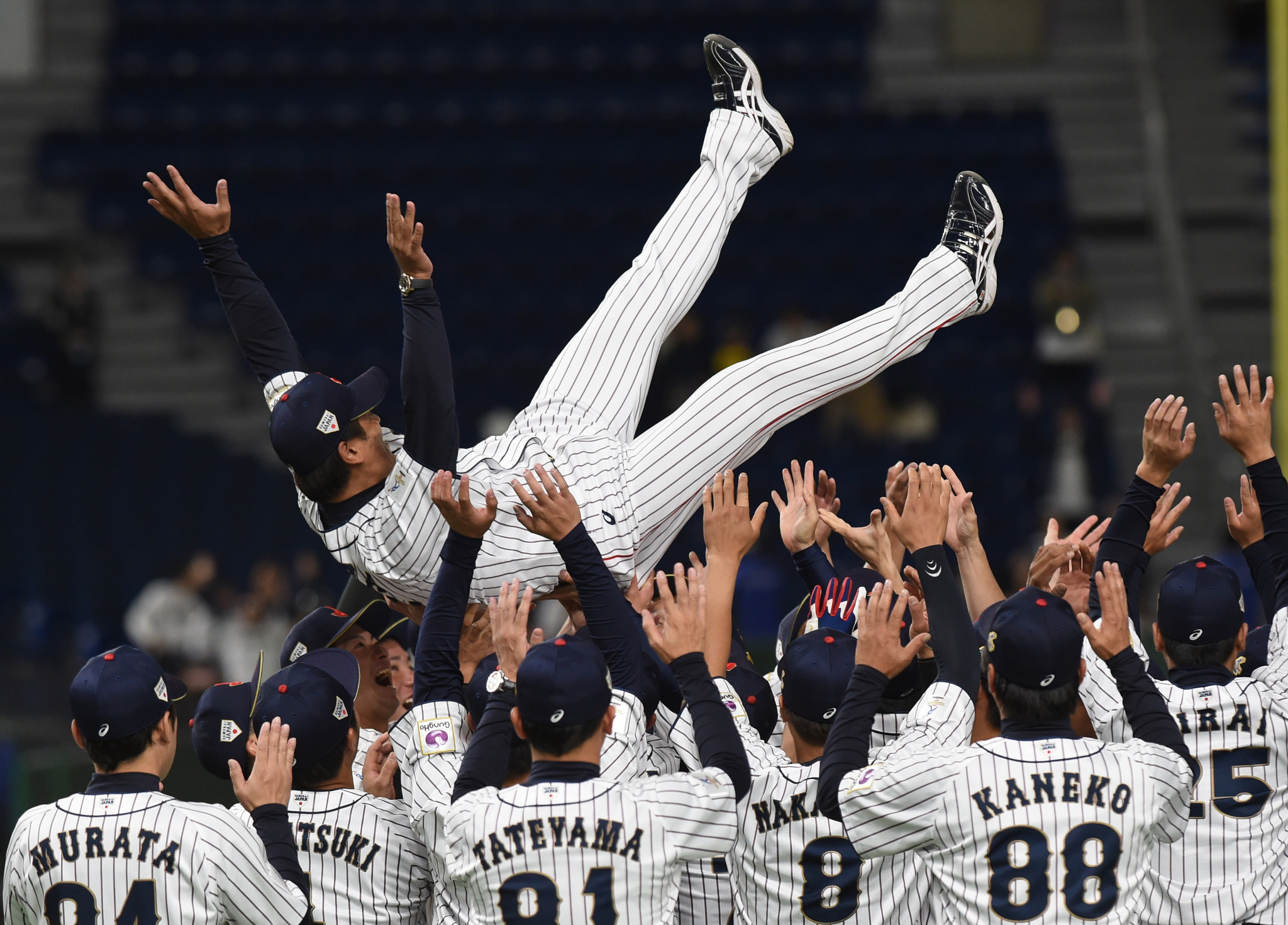 Atsunori Inaba, airborne, was manager when Japan won the 2019 WBSC Premier12 tournament ©Getty Images
