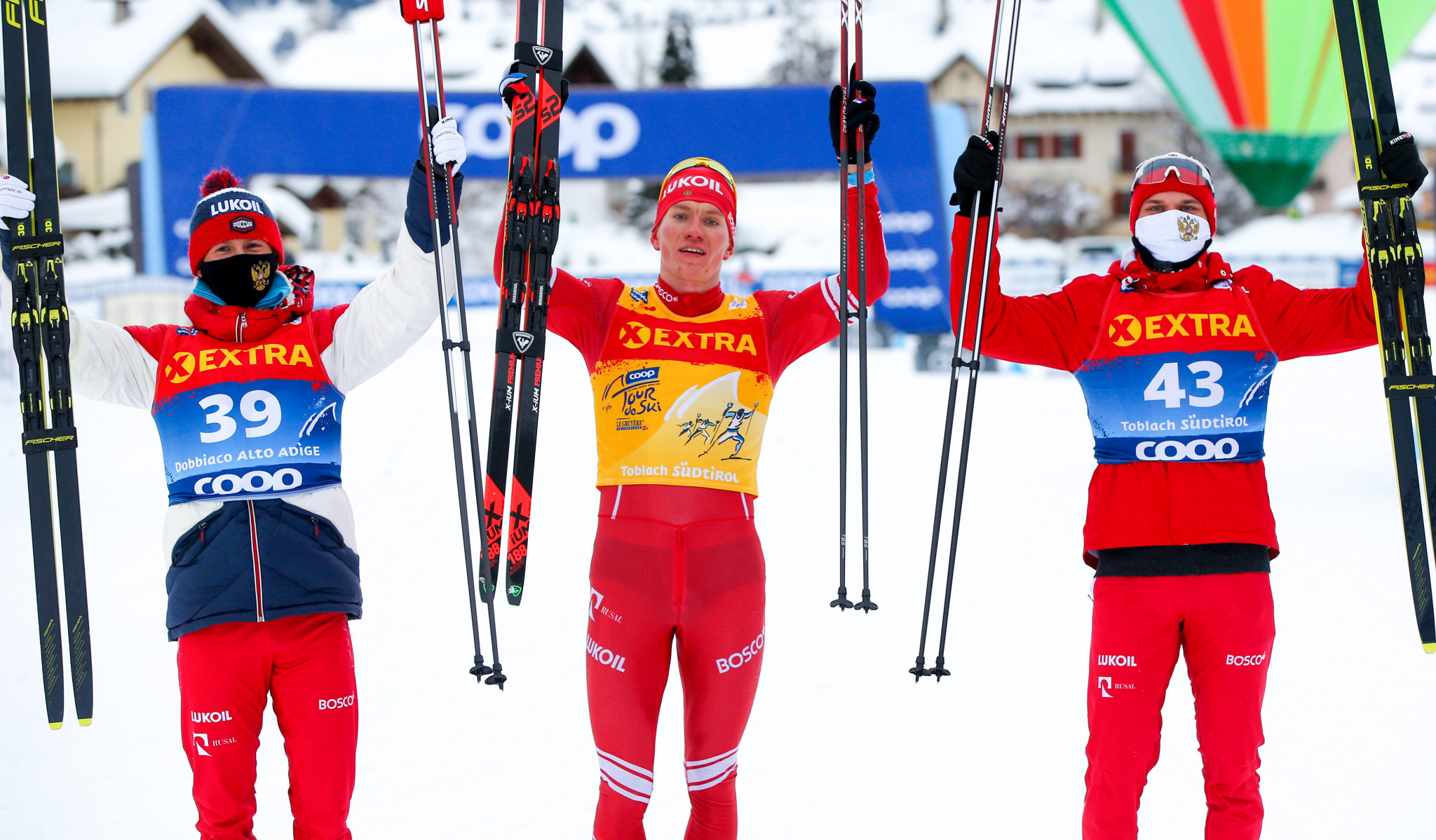 Alexander Bolshunov is flanked by compatriots Denis Spitsov and Ivan Yakimushkin after completing an all-Russian podium ©Getty Images