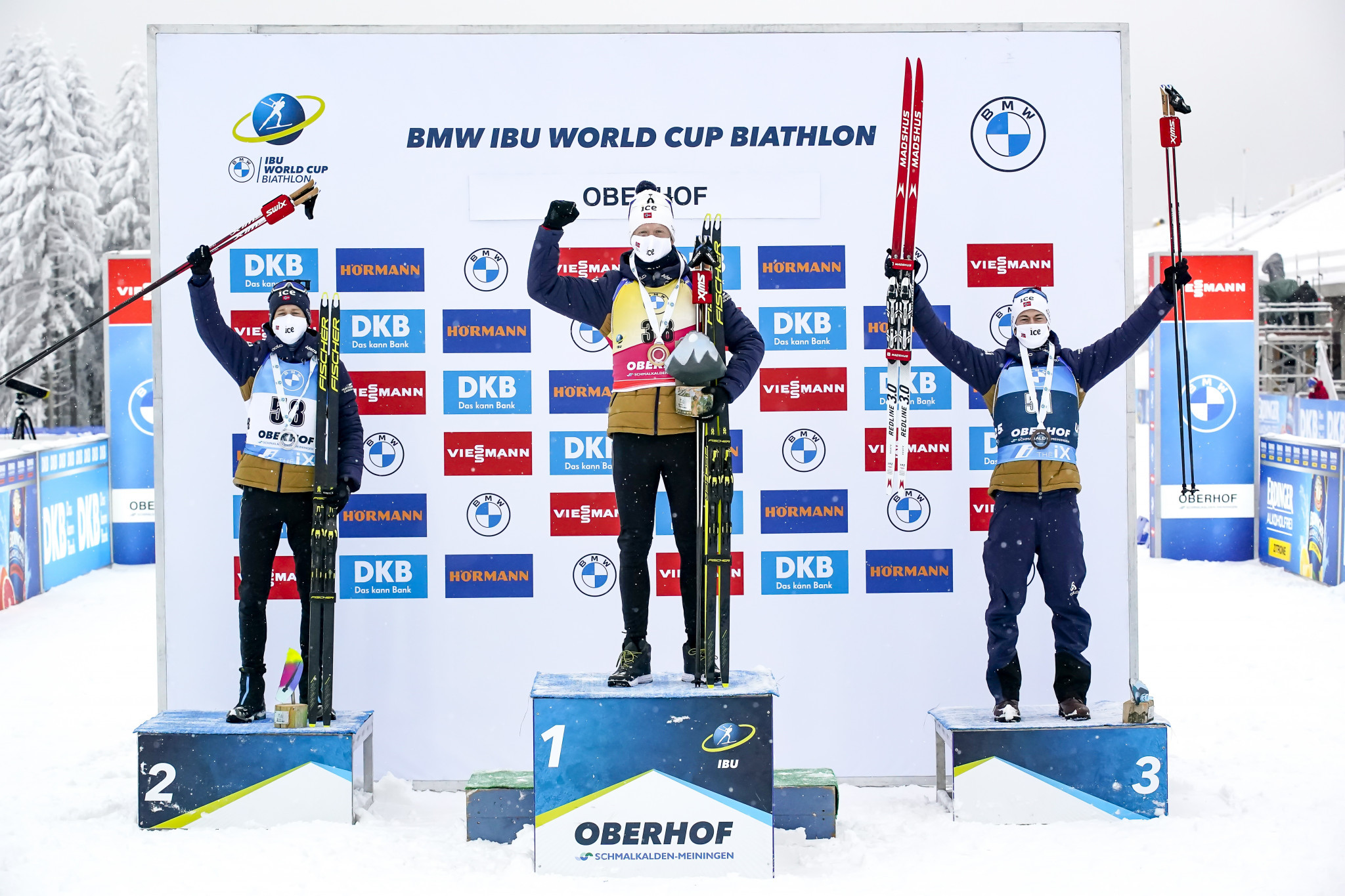 Johannes Thingnes Bø, centre, stands at the top of the podium in Oberhof alongside compatriots Tarjei Bø, left, and Sturla Holm Lægreid ©Getty Images