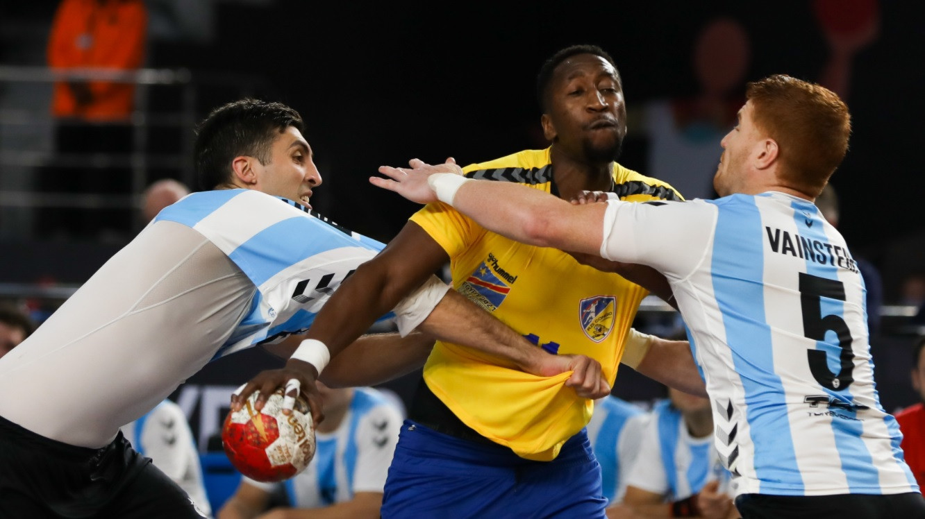 An Argentina player (blue and white) almost lost his shirt, although the team won a physical match as they beat DR Congo at the World Men's Handball Championship in Egypt ©Handball Egypt