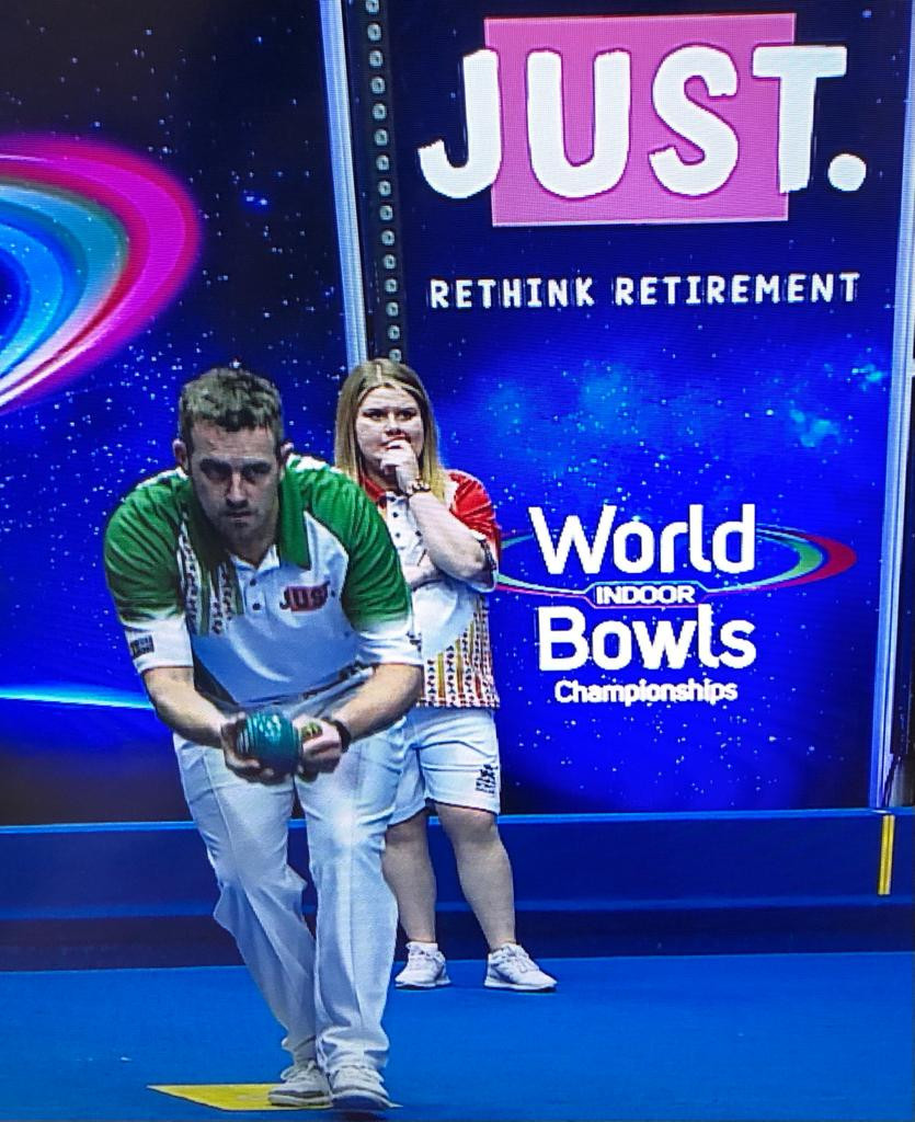 Katherine Rednall (in red) became the second woman to reach round two of the World Indoor Bowls Championships open singles competition after beating Stuart Irwin ©World Bowls Tour