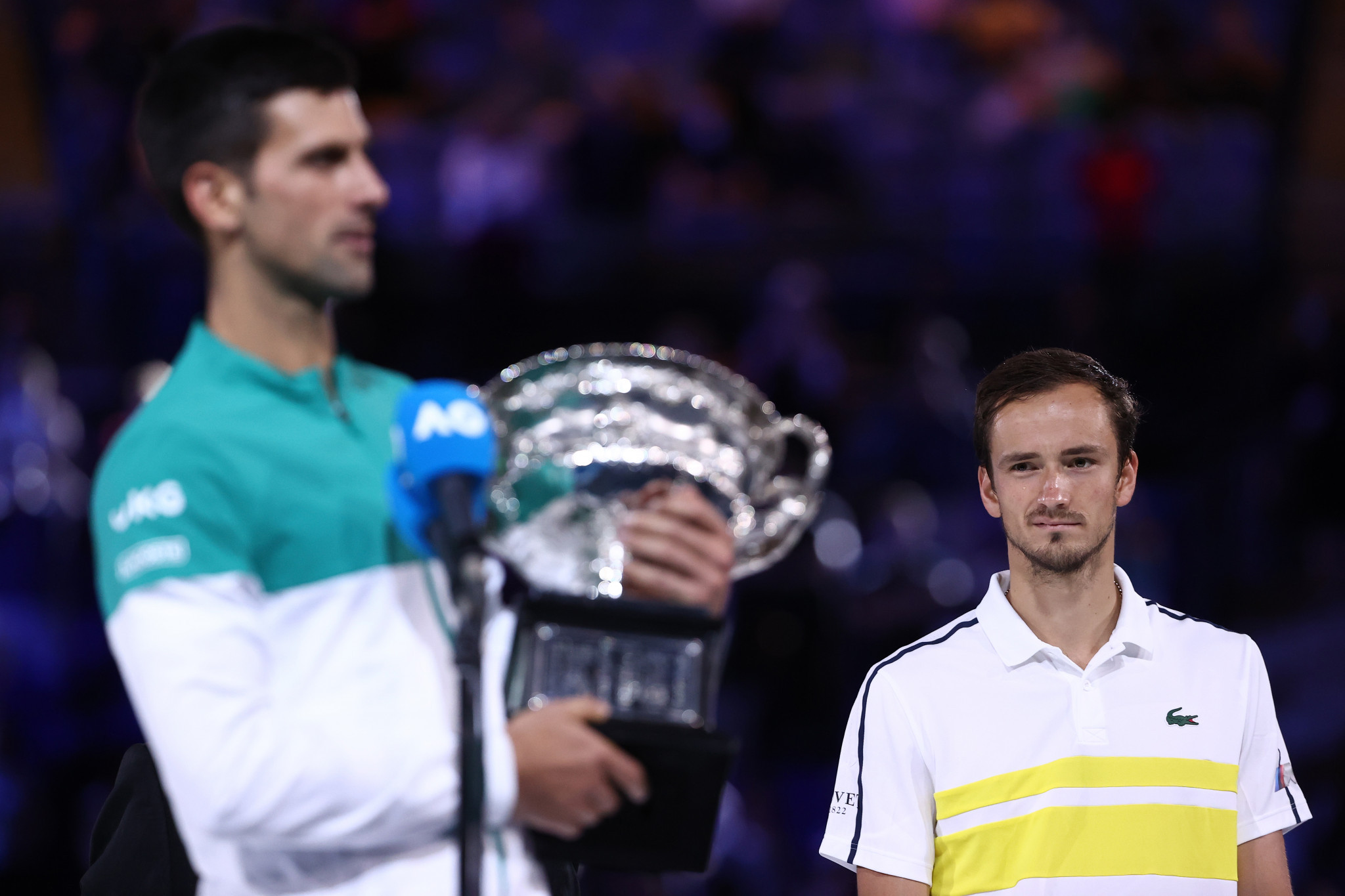 Medvedev watches on as Djokovic gives his victory speech with the trophy in his arms ©Getty Images