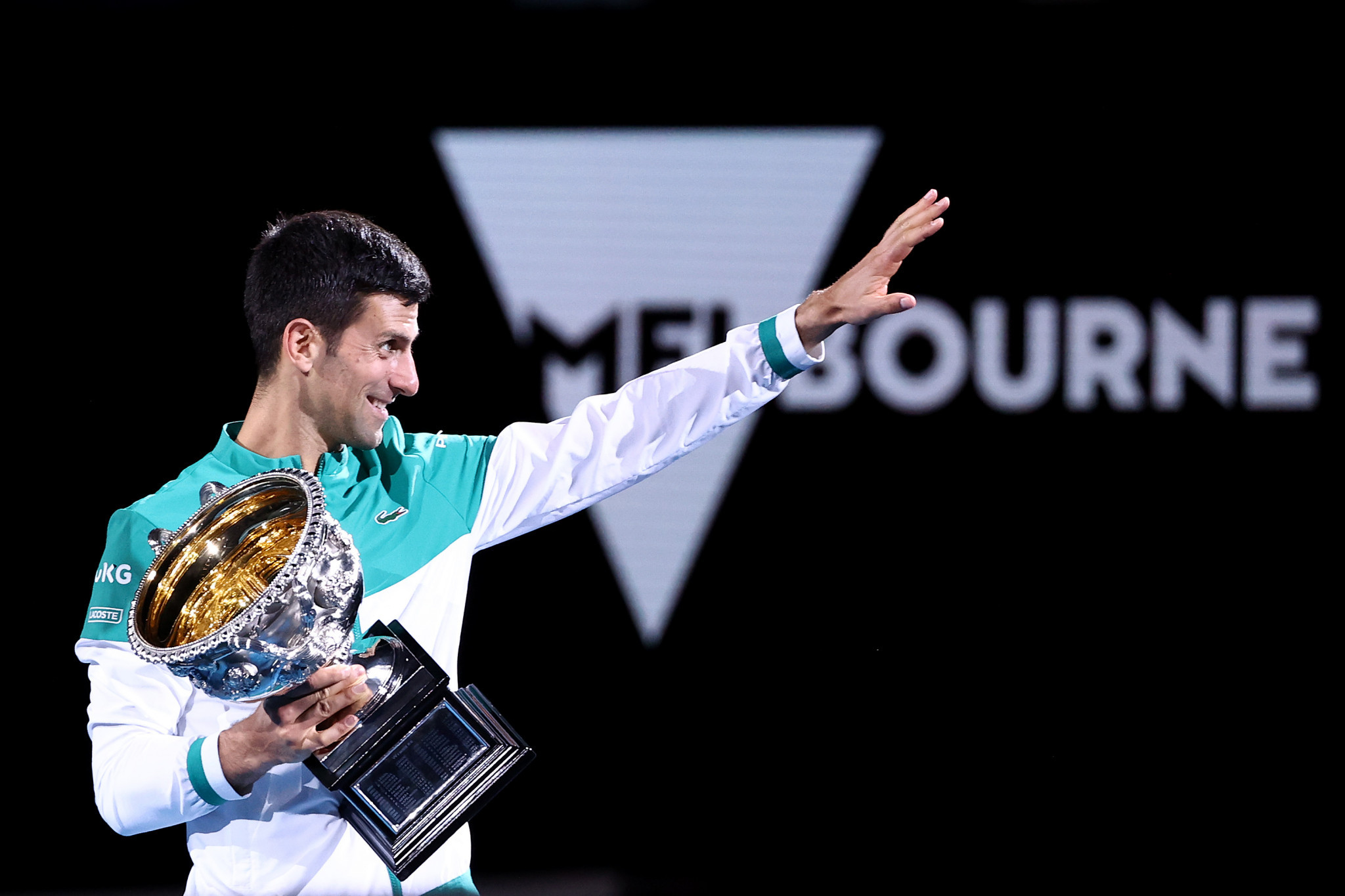 Djokovic waves to his supporters after collecting the trophy for the ninth time ©Getty Images
