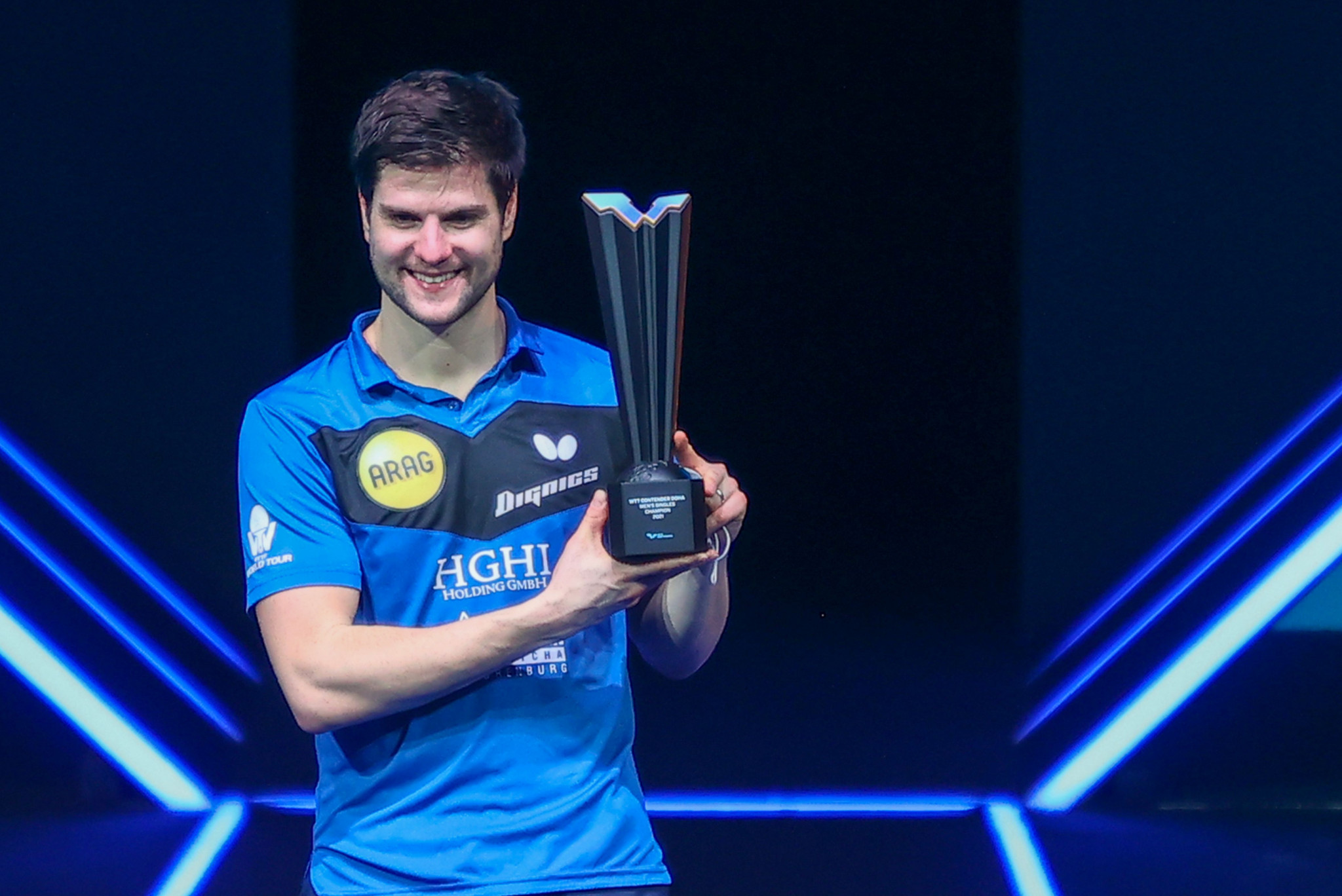 Dimitrij Ovtcharov poses with the men's singles trophy after winning the WTT Contender event in Doha ©Getty Images