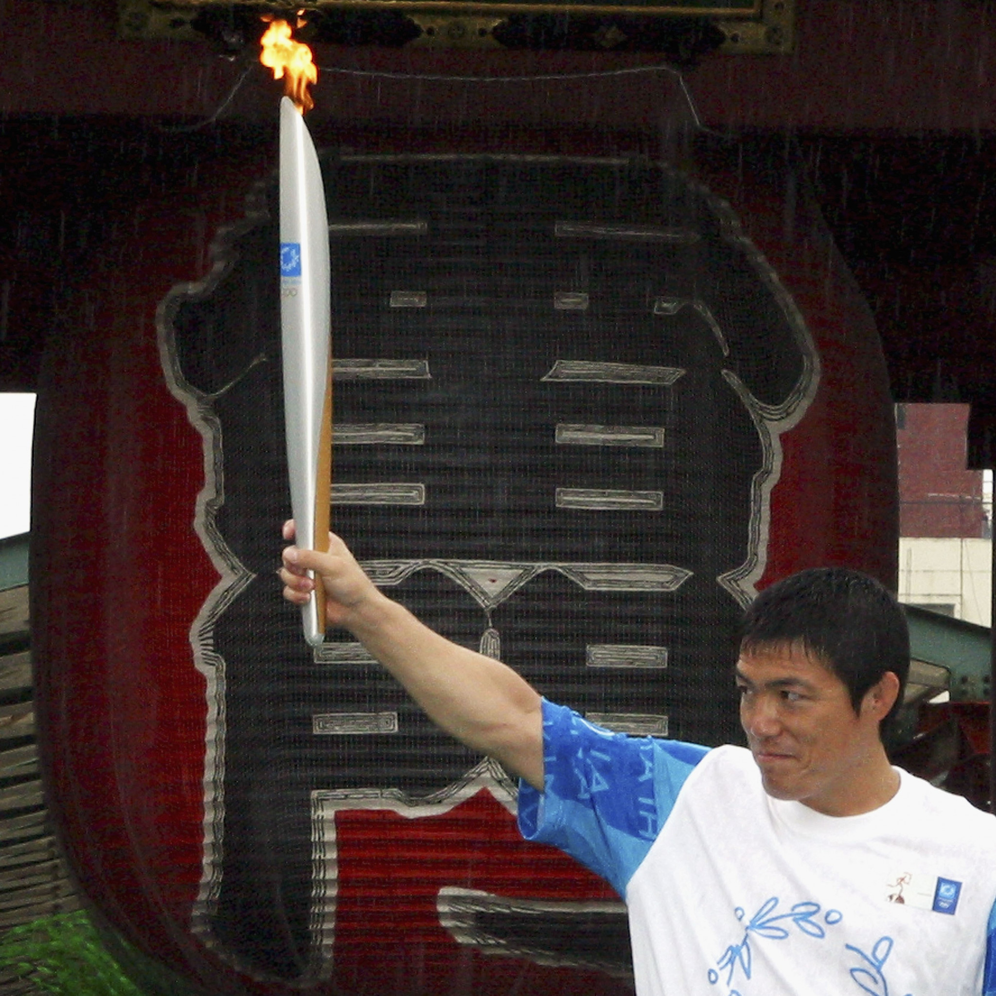 Toshihiko Koga, Japan’s 1992 Olympic gold judo medallist pictured with the Olympic torch ahead of the 2004 Athens Games, who died this week aged 53 having had cancer, was honoured by a minute's silence during the draw for the IJF Tbilisi Grand Slam that starts tomorrow ©Getty Images
