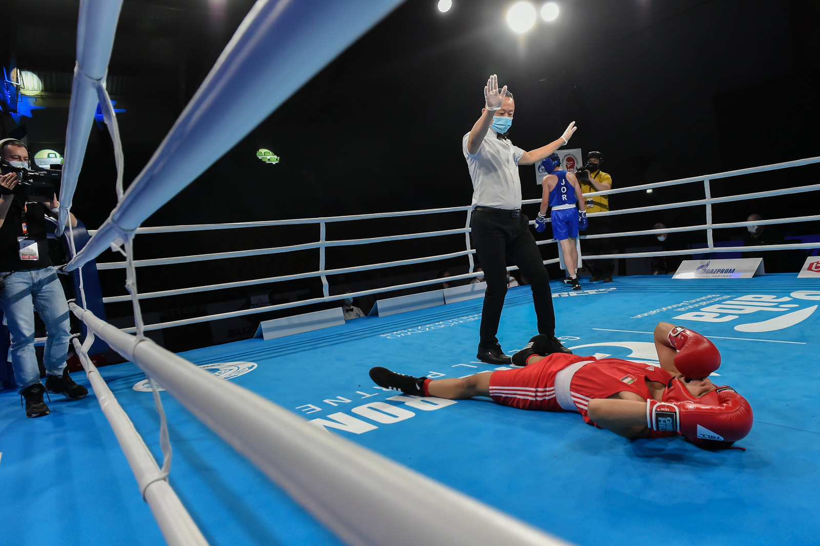 The referee calls a halt to proceedings as a fighter hits the canvas ©AIBA