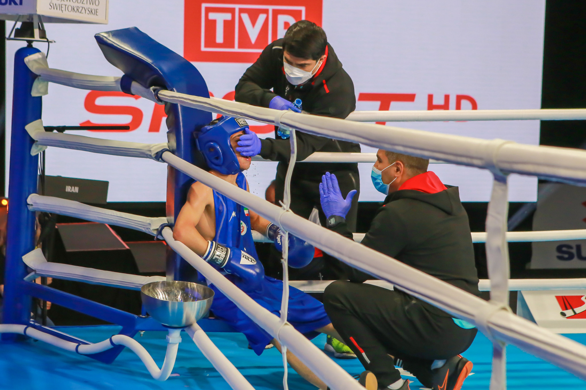 A boxer is attended to between rounds by his team ©AIBA