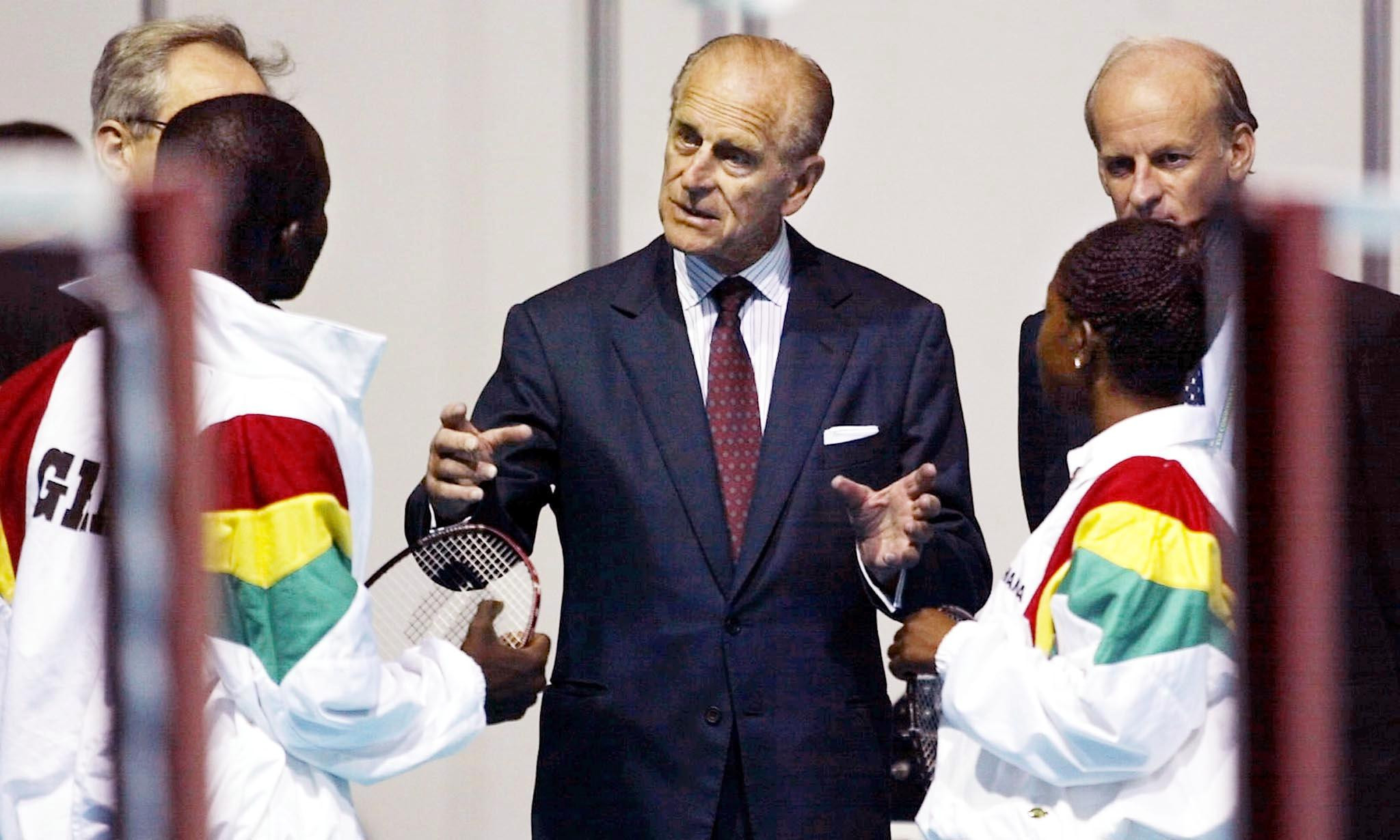Prince Philip chats to a mixed doubles badminton team from Ghana during the Manchester 2002 Commonwealth Games ©Getty Images