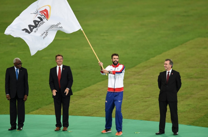 Britain's 400m specialist Martyn Rooney takes over the IAAF flag for London 2017 at the handing-over ceremony during the IAAF World Championships last year. Britain's 'local heroes' will have an enhanced opportunity to see him and others compete next year ©Getty Images