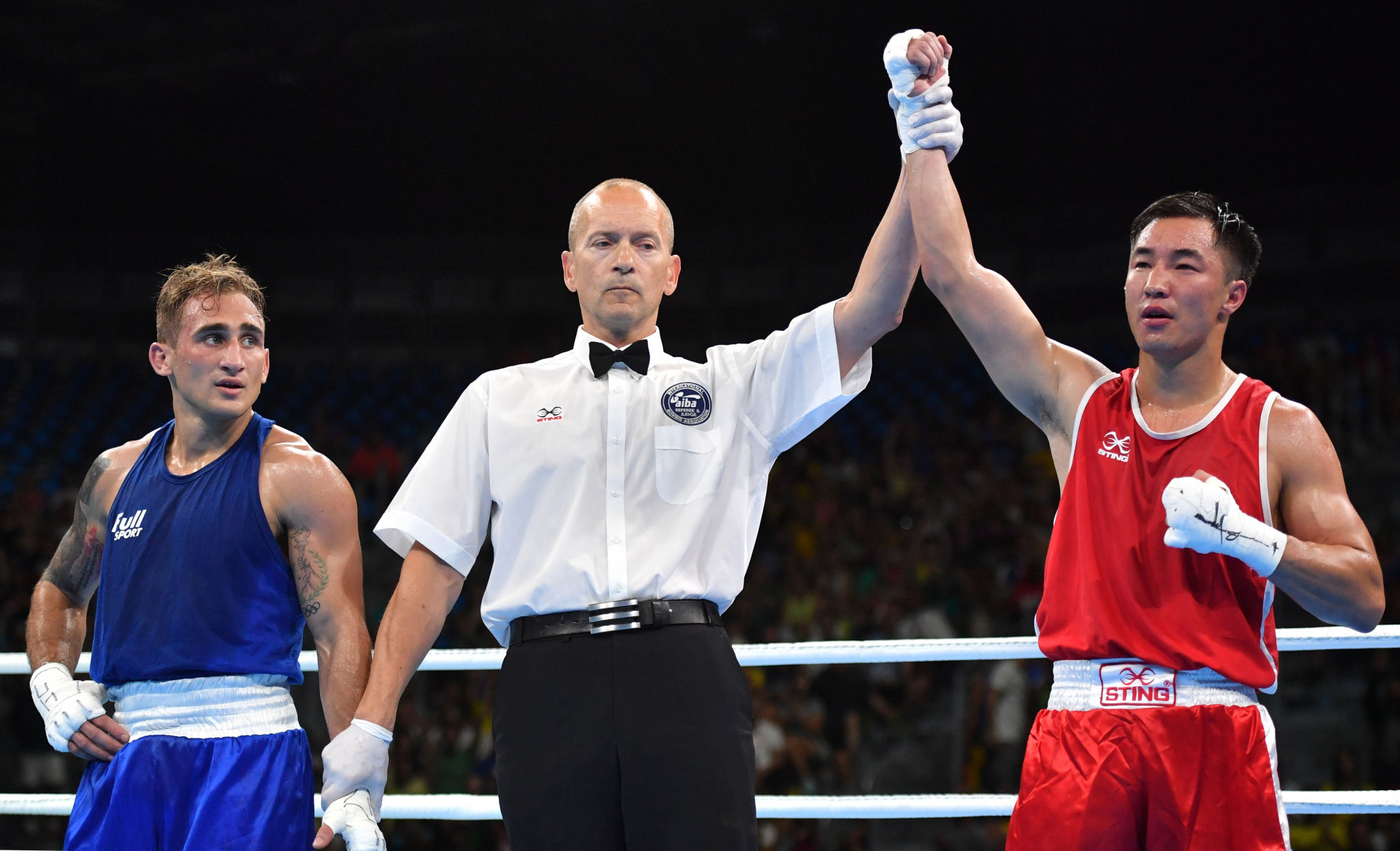 A boxing referee raises the winner's hand at the Rio 2016 Olympics ©Getty Images