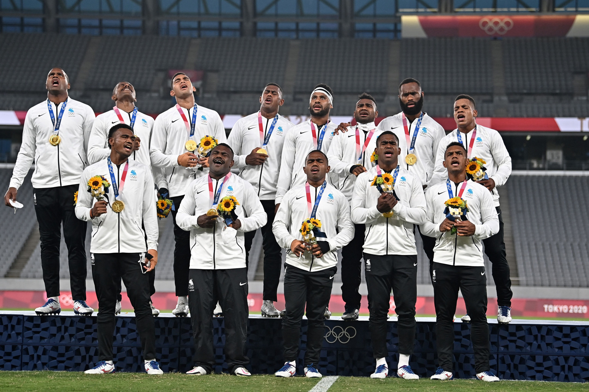 Fiji sing their national anthem after collecting their gold medals at Tokyo Stadium ©Getty Images