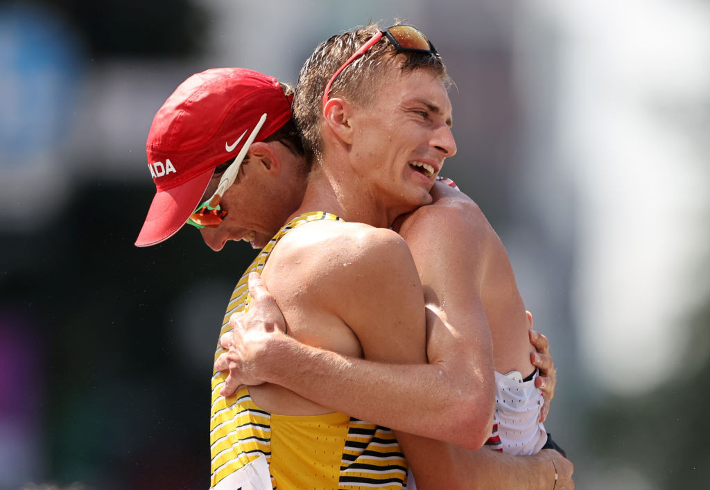 Respective silver and gold medallists Evan Dunfee of Canada and Germany's Jonathan Hilbert embrace at the end of the last Olympic men's 50km race walk, which was held in Sapporo's Odori Park ©Getty Images