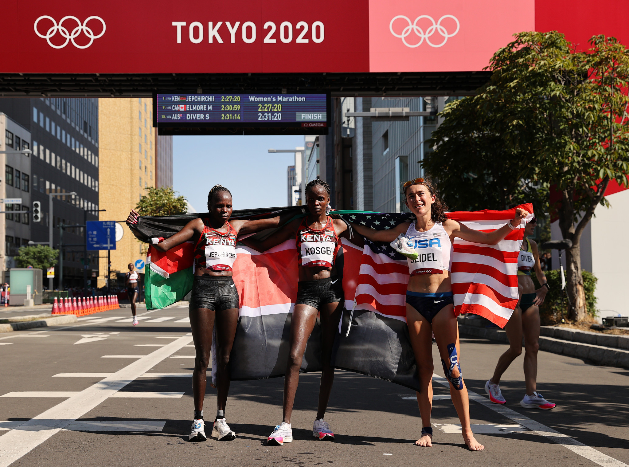 Kenya's Olympic marathon winner Peres Jepchirchir, left, with the silver and bronze medallists, team-mate Brigid Kosgei and the United States' Molly Seidel of the United States ©Getty Images